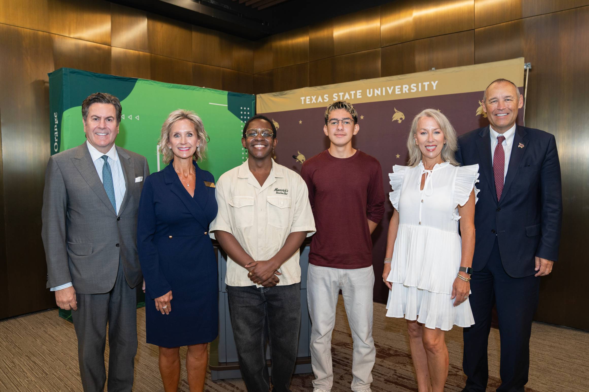a group of people at a signing ceremony 