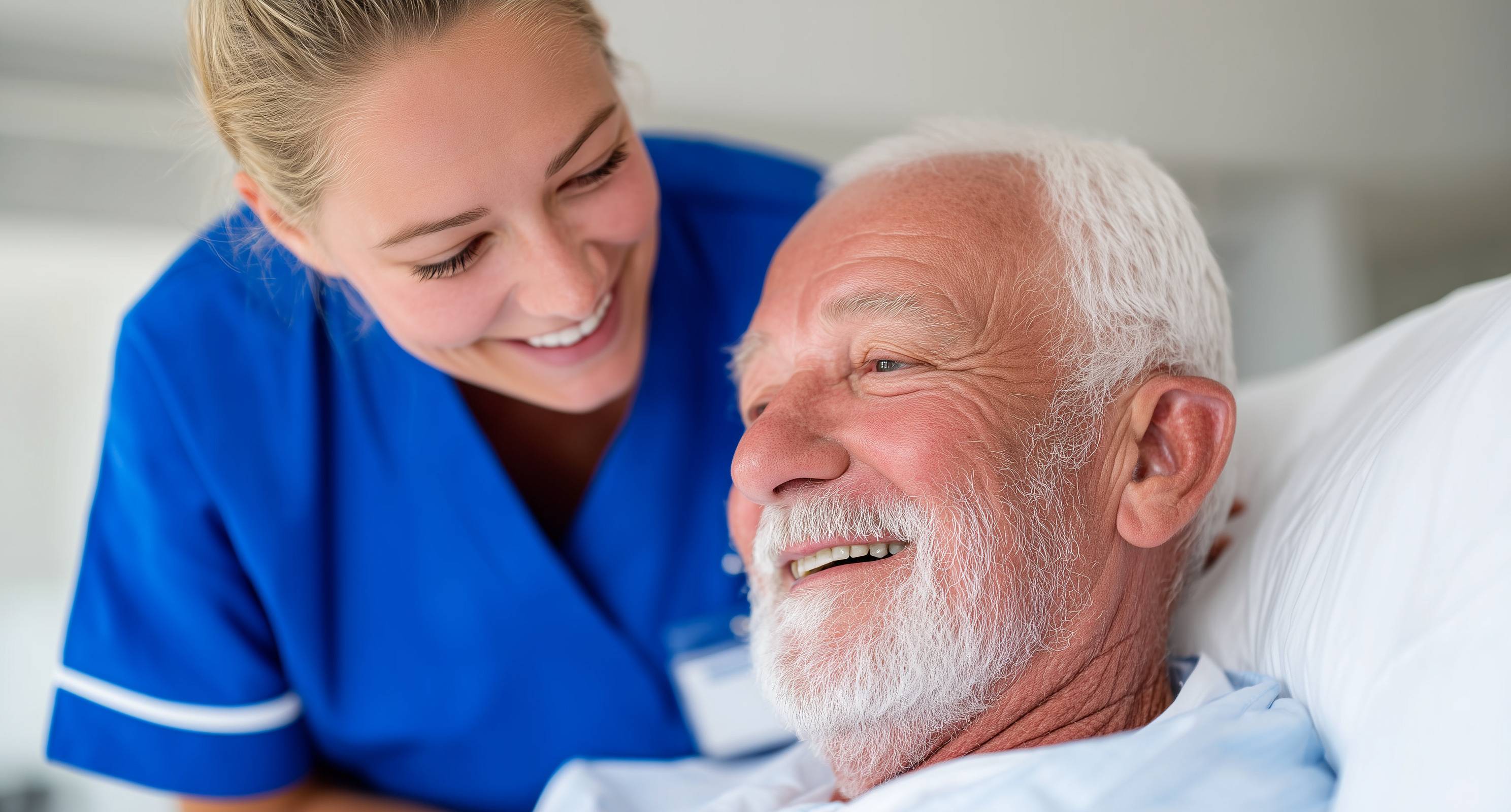 Older man being checked in on by nurse.