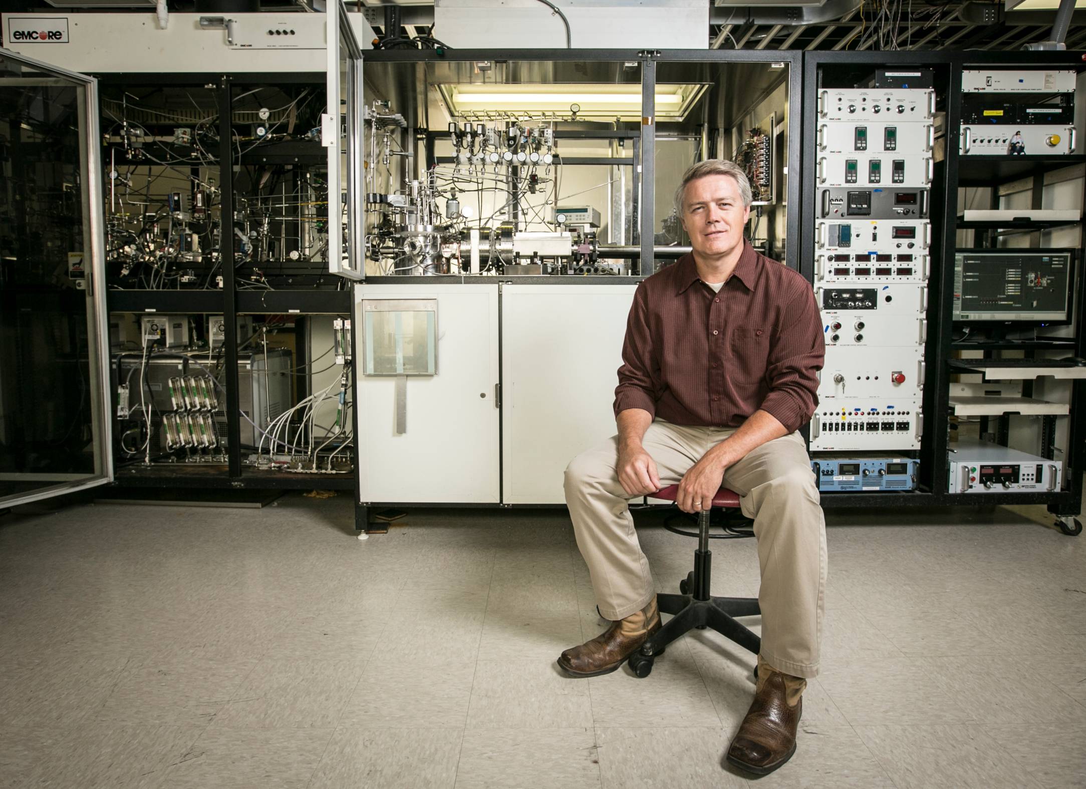 a man sitting on a chair in an engineering lab