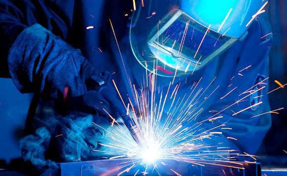 a welder welding with a welding mask on