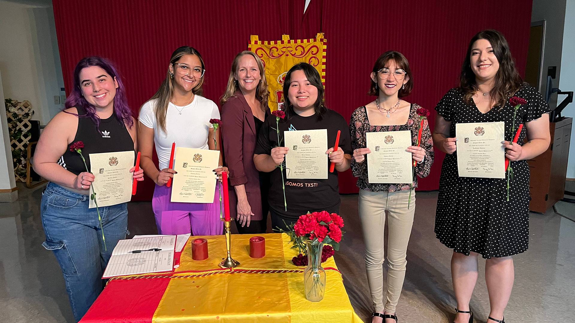 honors students posing for a group photo holding awards certificates