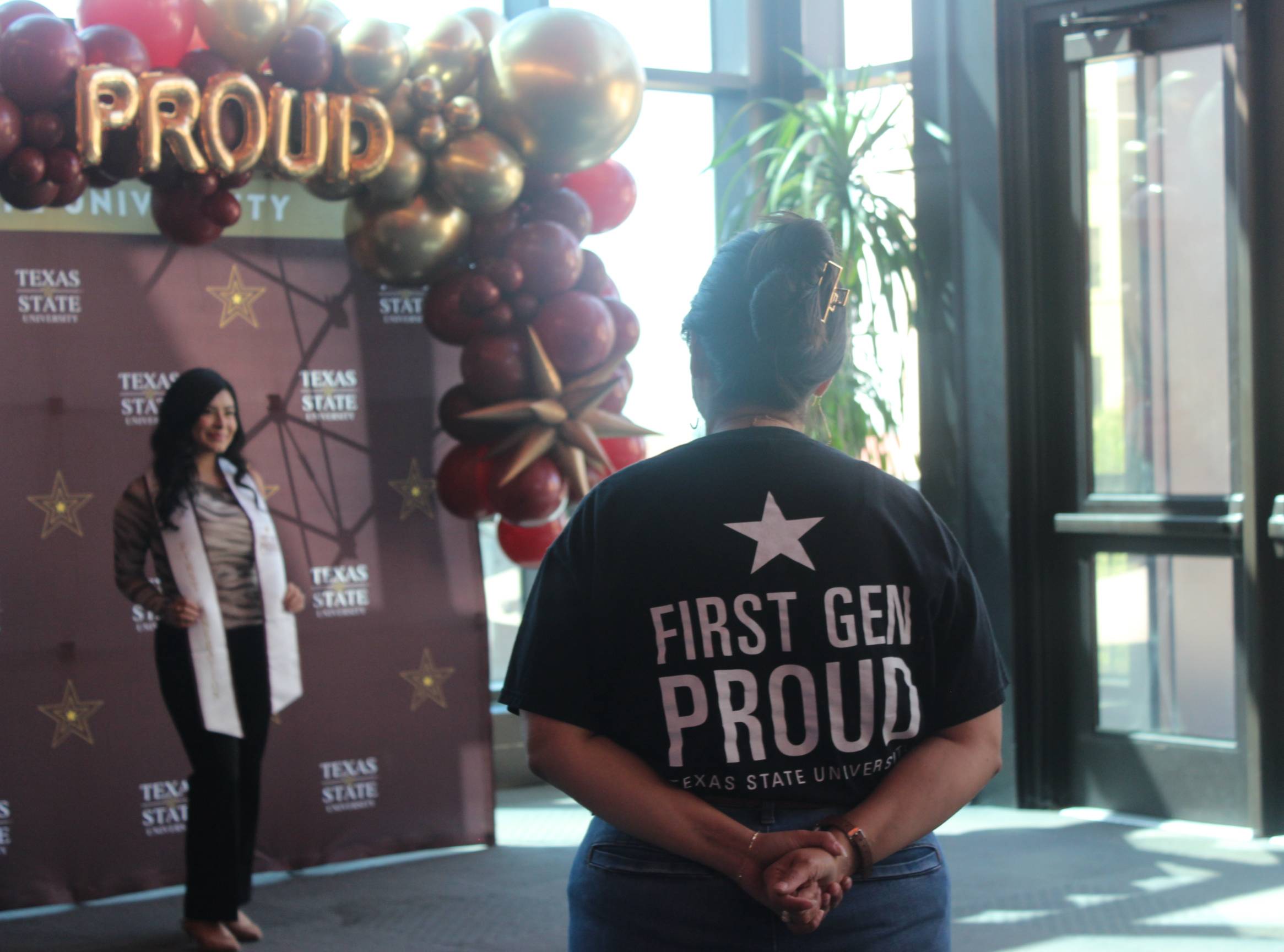 Image depicts three Texas State Students posing with the First-Gen Proud graduation stoles