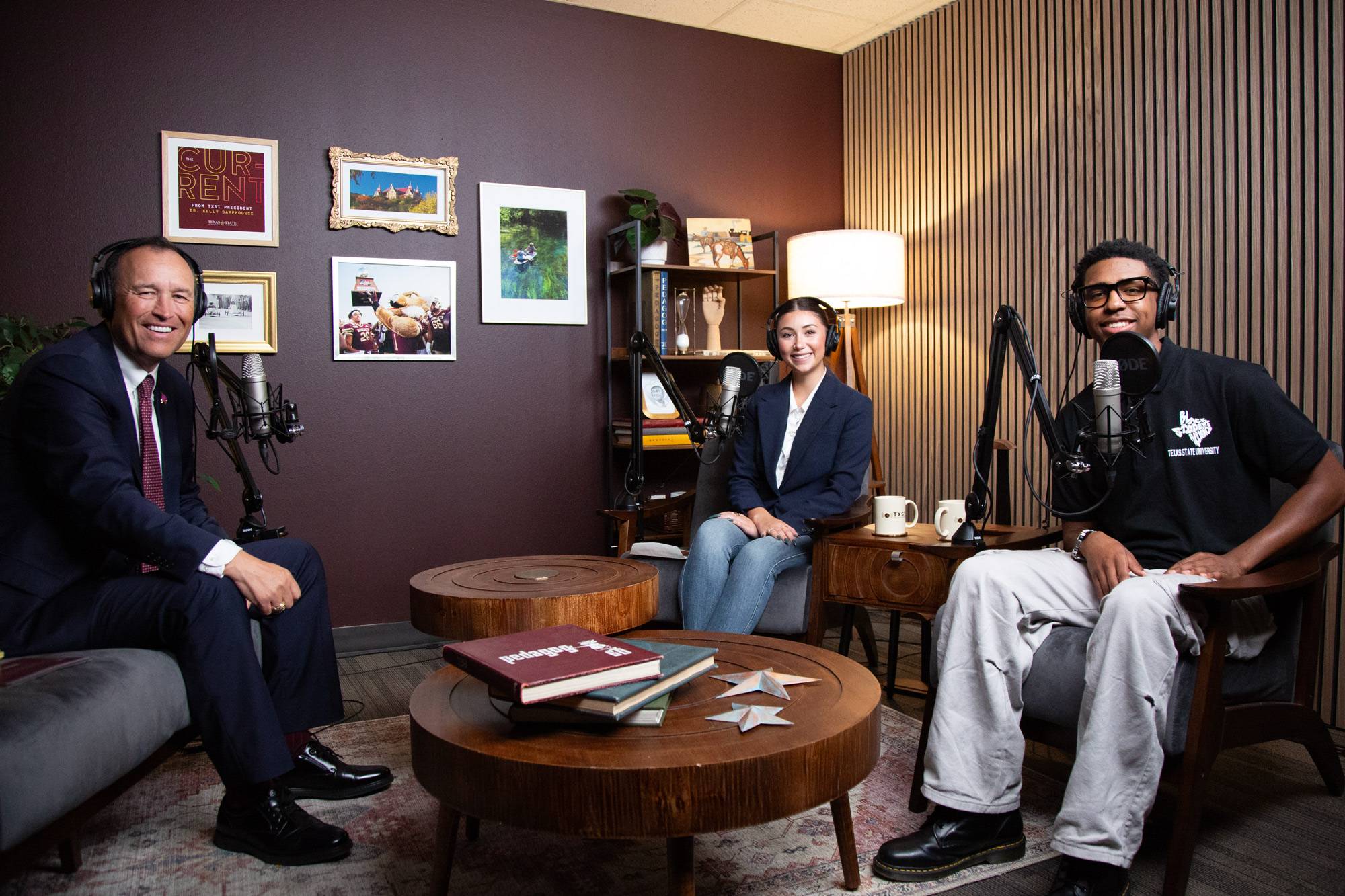 President Damphousse posing with two students in podcast studio