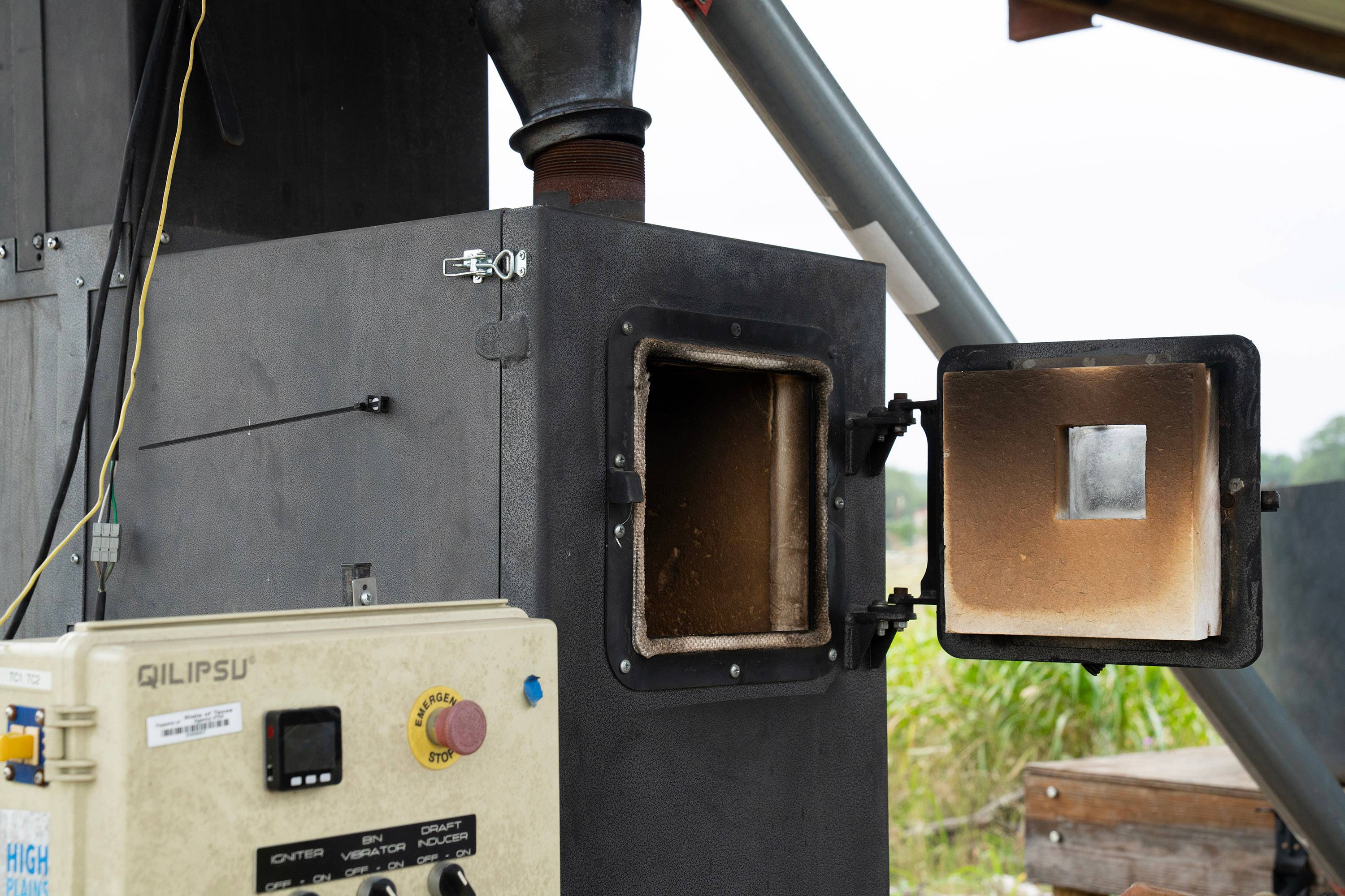 A furnace, that looks like a large box, with a door open