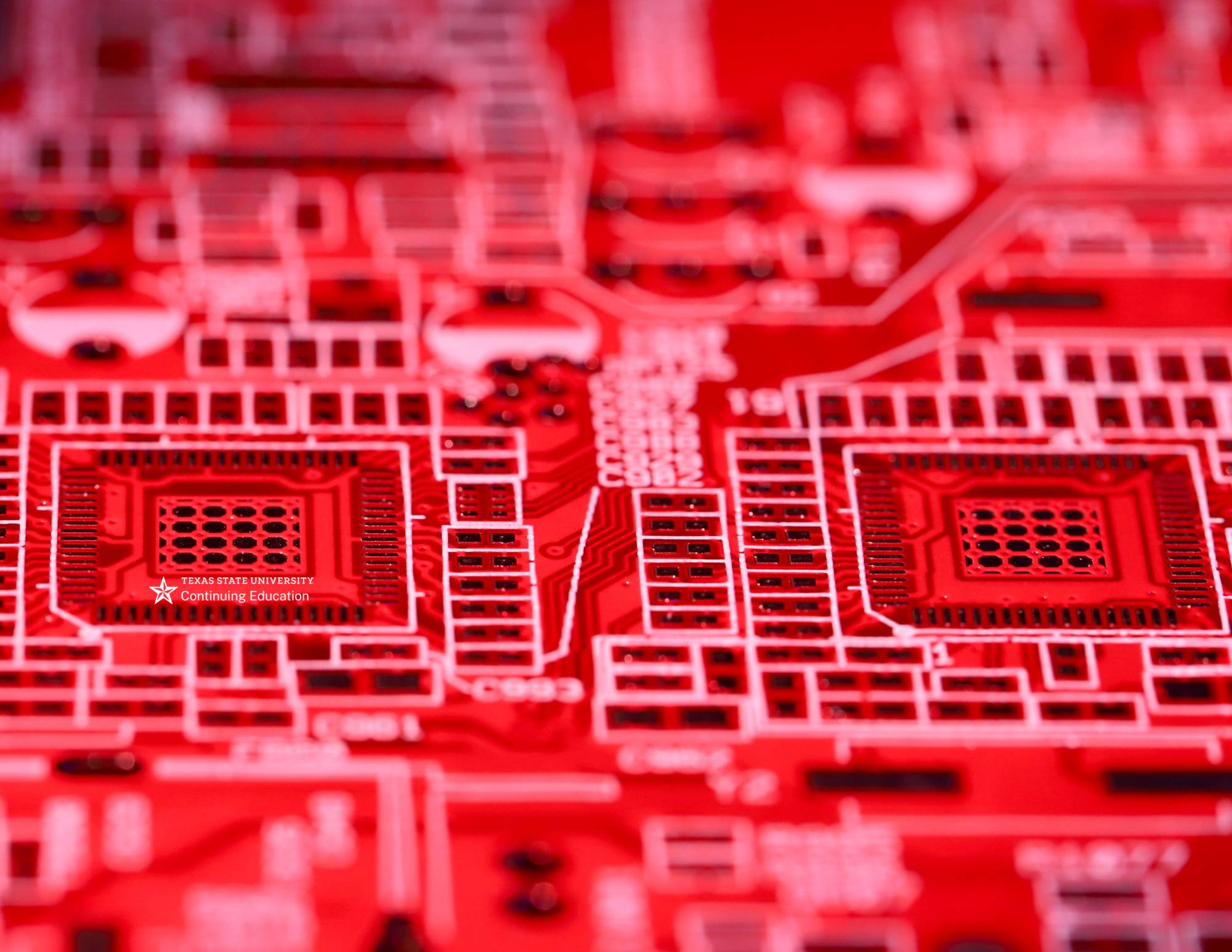 a red circuit board with white circuitry