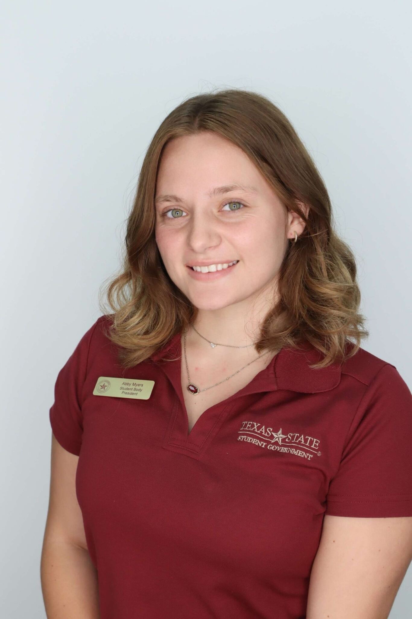 Headshot of Abby Myers wearing a maroon shirt