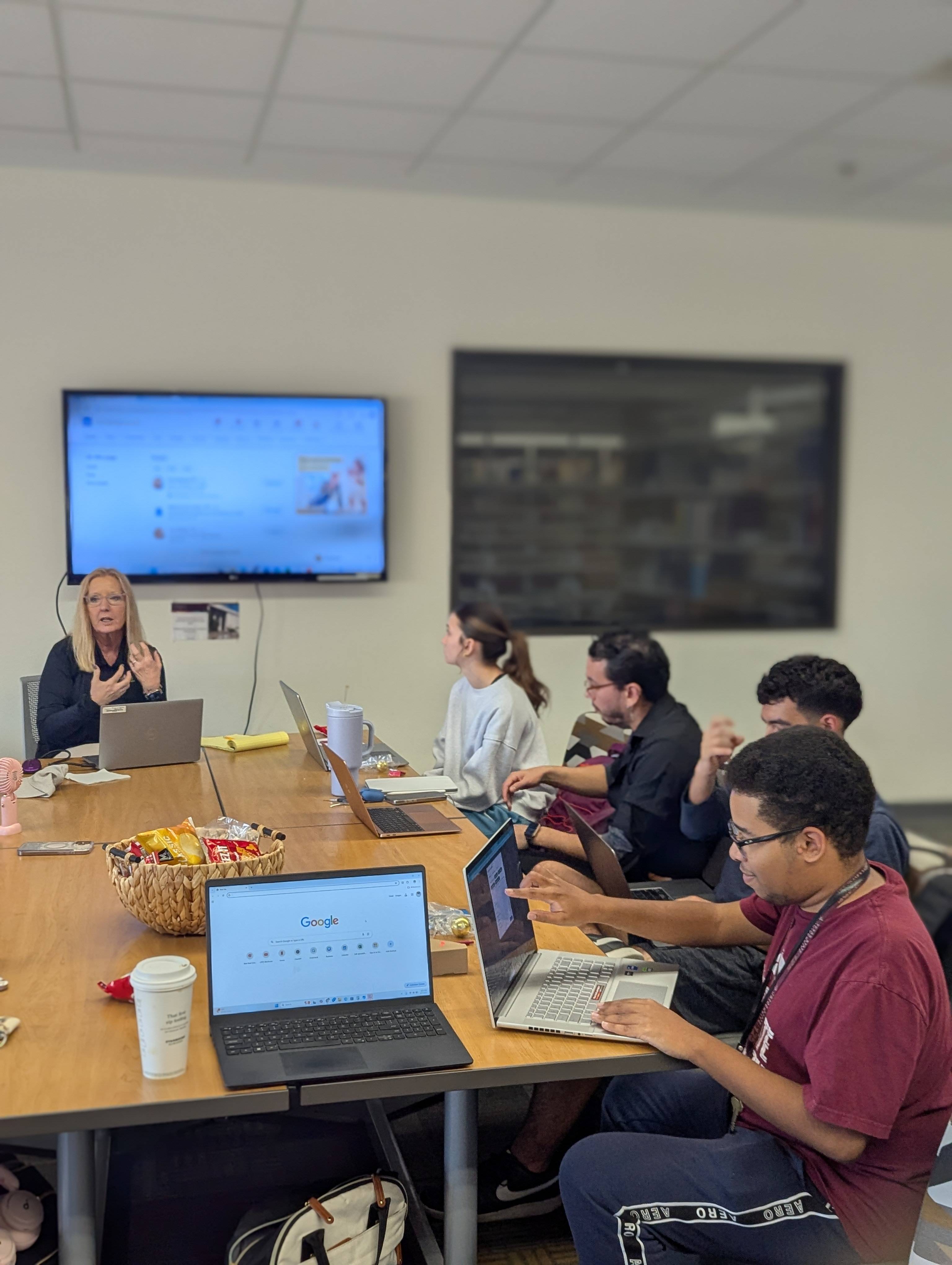 Students at a Wednesday Workshop in the CIE gathering space listening to Quinn