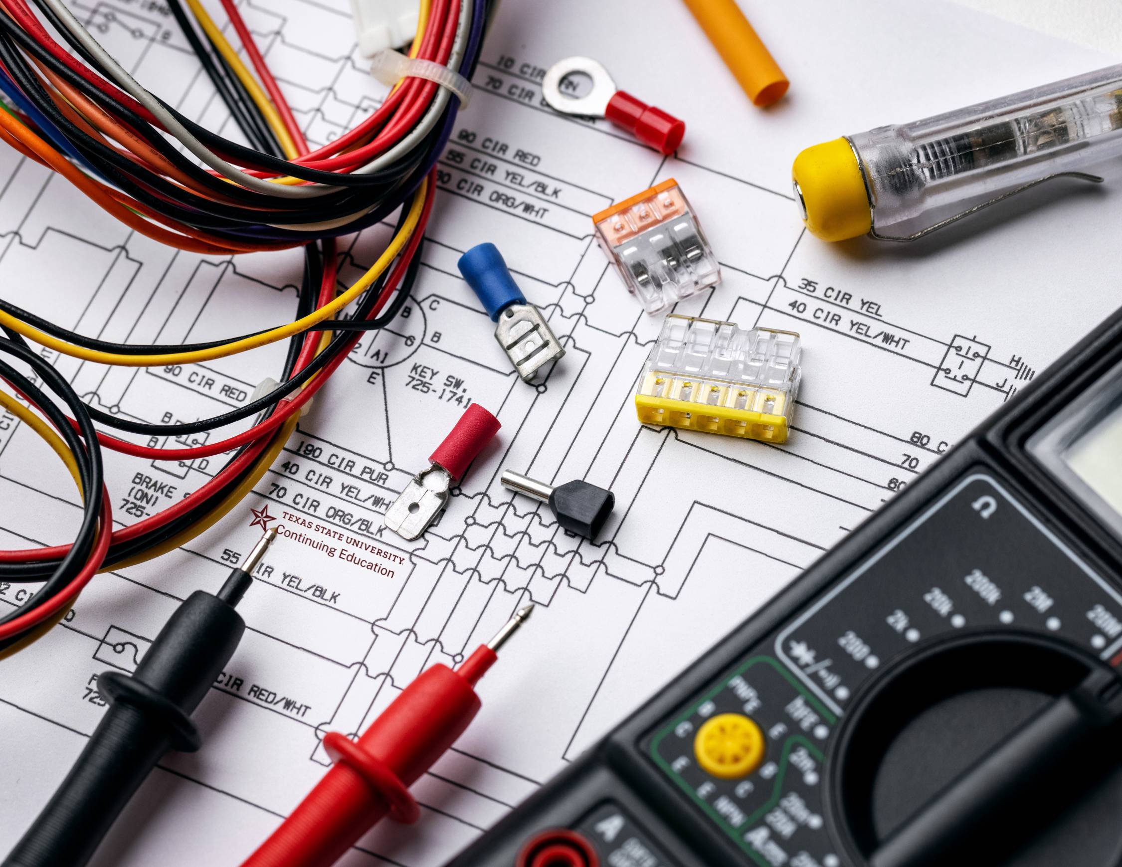 wires, fuses and plugs laid on an electrical map