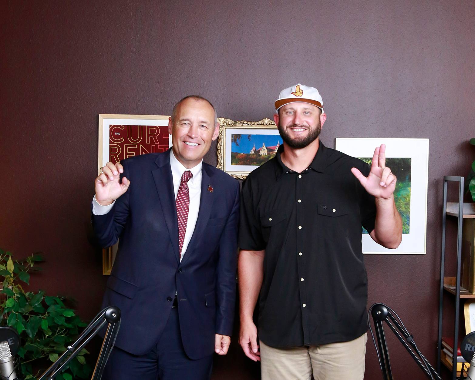damphousse and coach kinne holding up txst hand signs