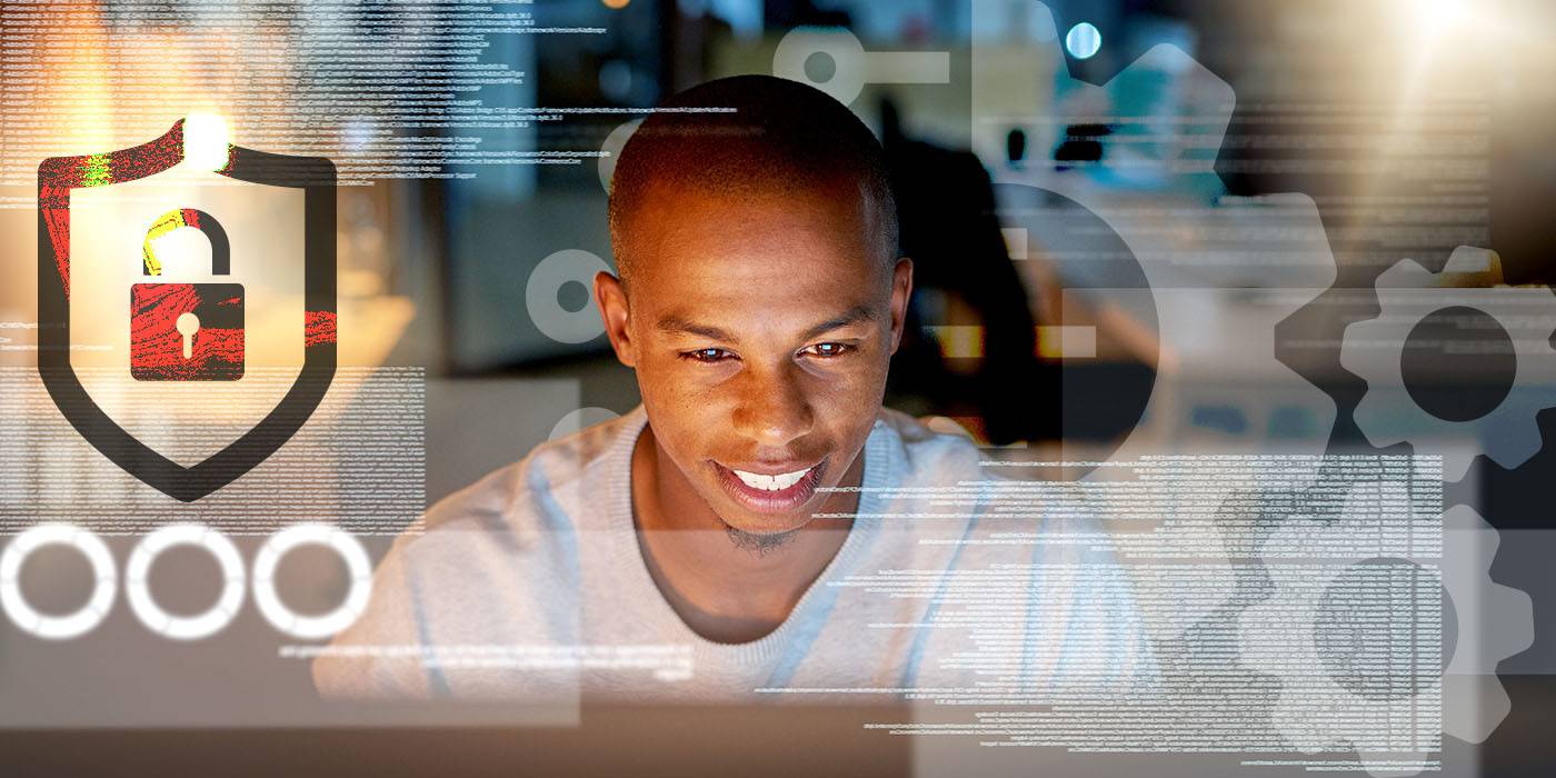 smiling man in front of computer screen