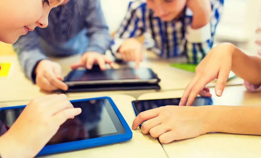 kids looking at tablets in the classroom