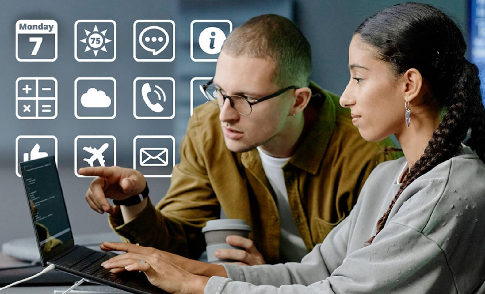 a man and woman discussing things on a laptop screen