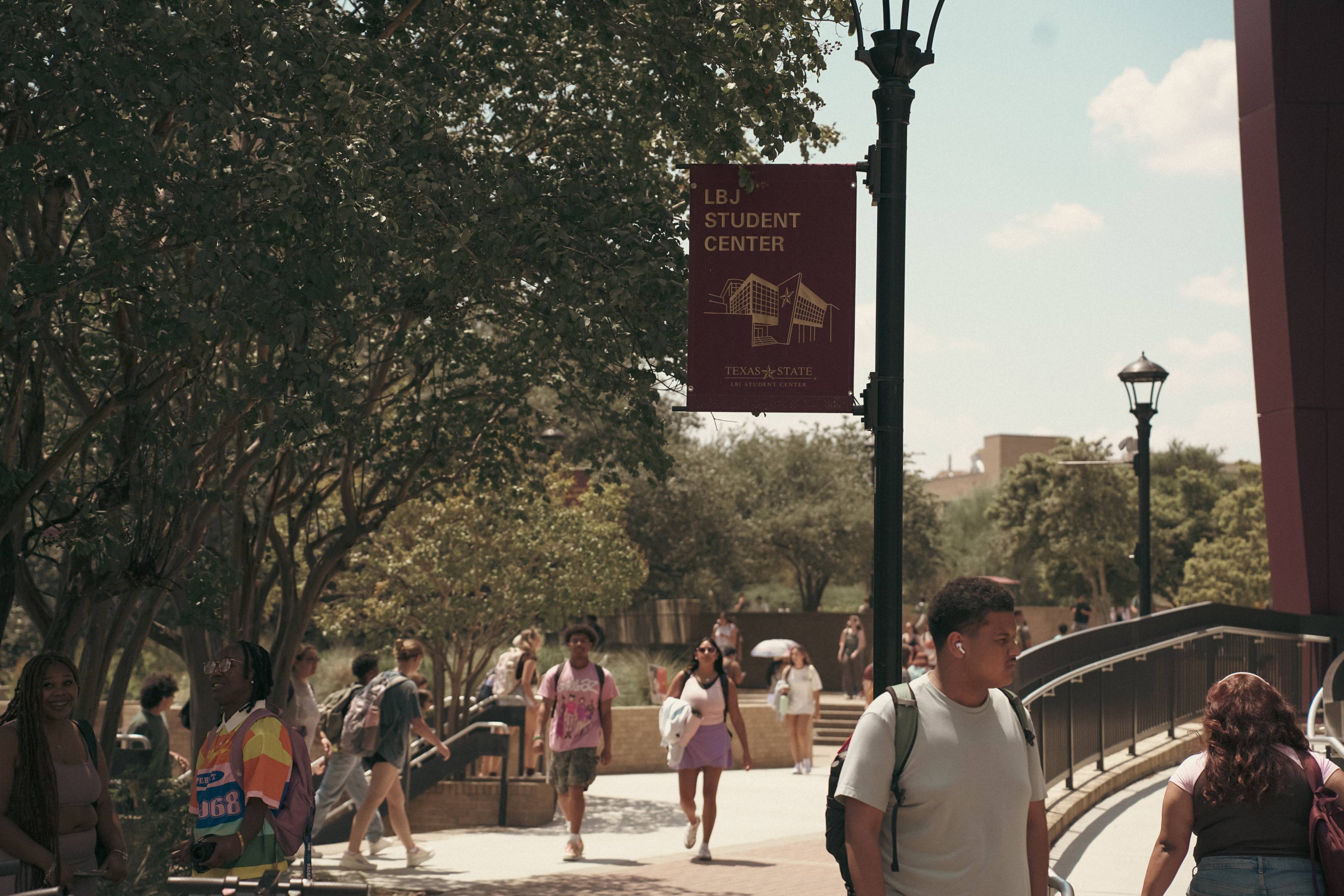 People walking through LBJ Mall 