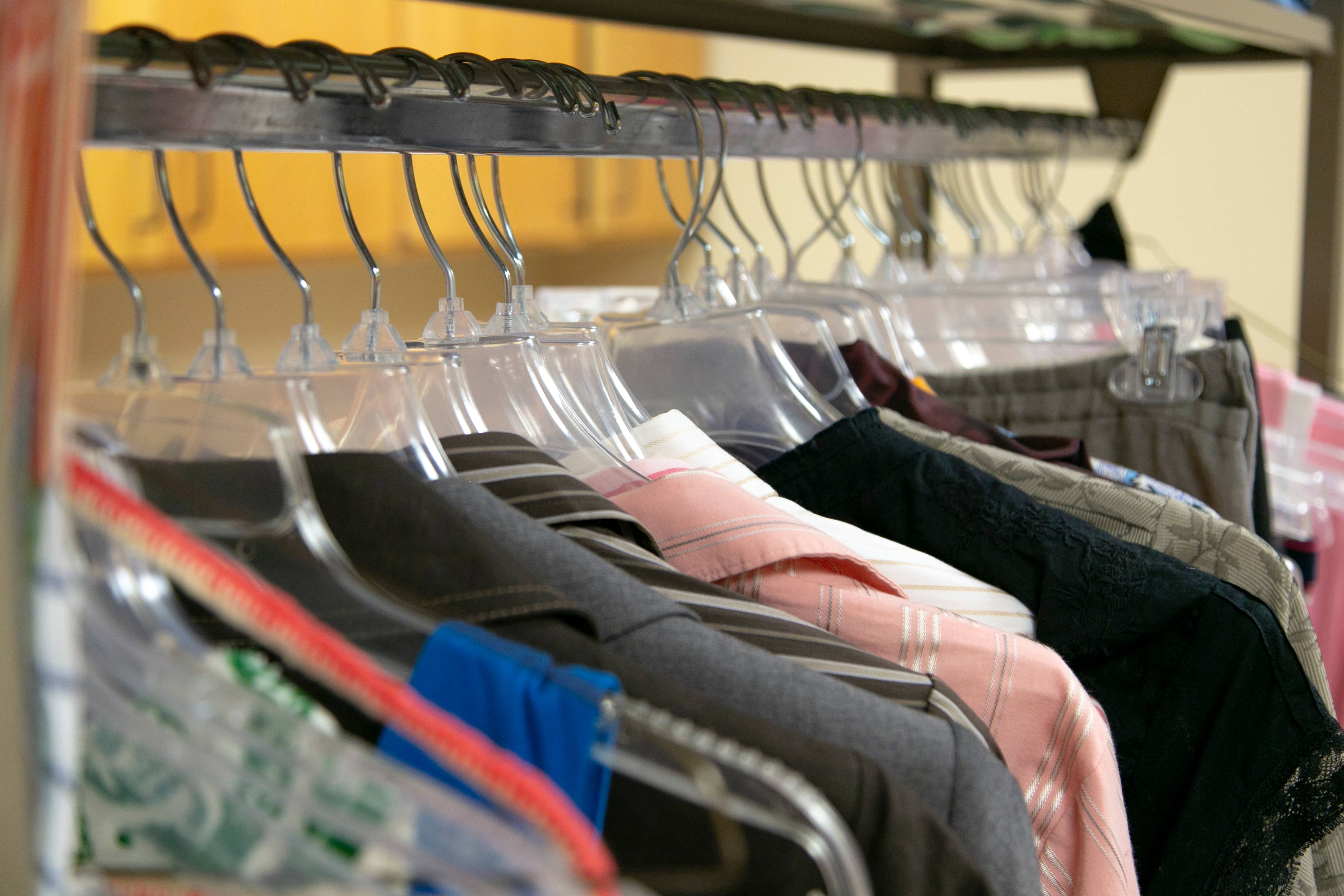 people looking at clothing and holding up articles of clothing