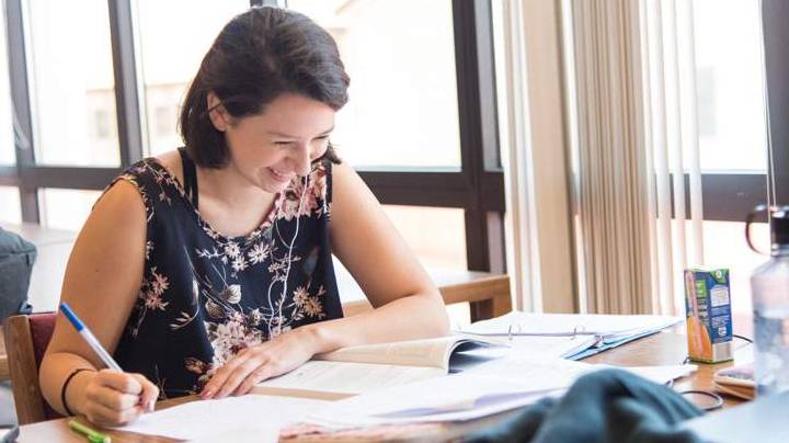 A female student studies in a public area