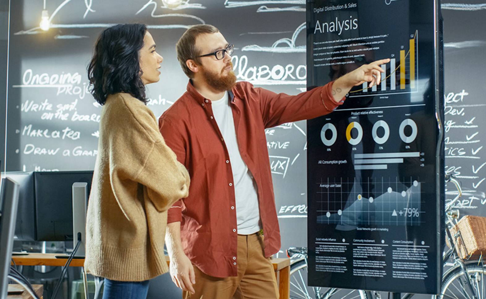 woman and man looking at digital representation of marketing data