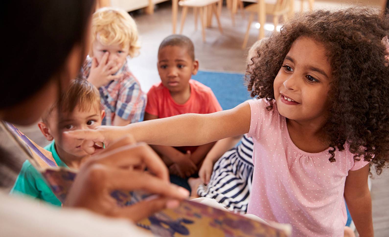 Children sitting on a wooden floor