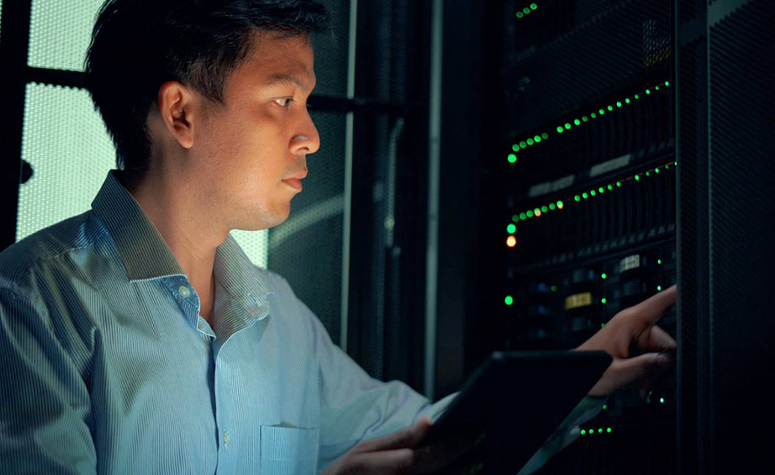 A man typing on a computer with a security lock icon on it. 