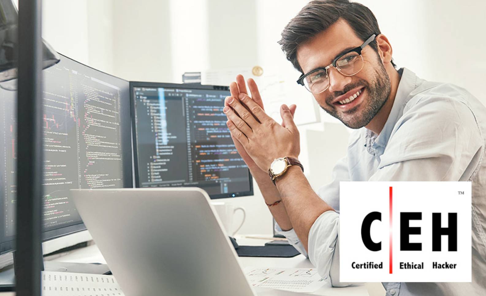 Man sitting in front of a screen with code. 