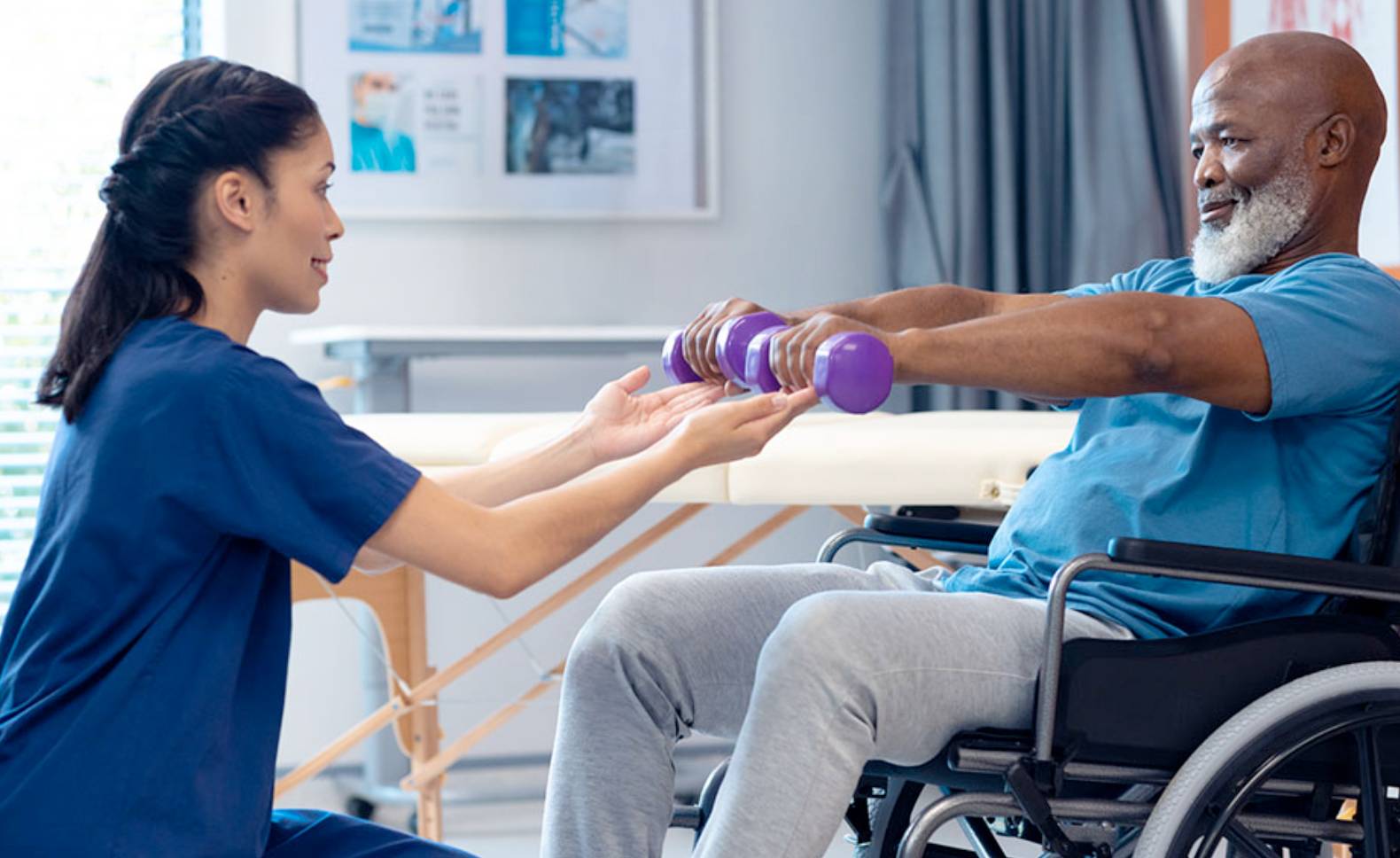 A physical therapy aid holding a patient's hands. 