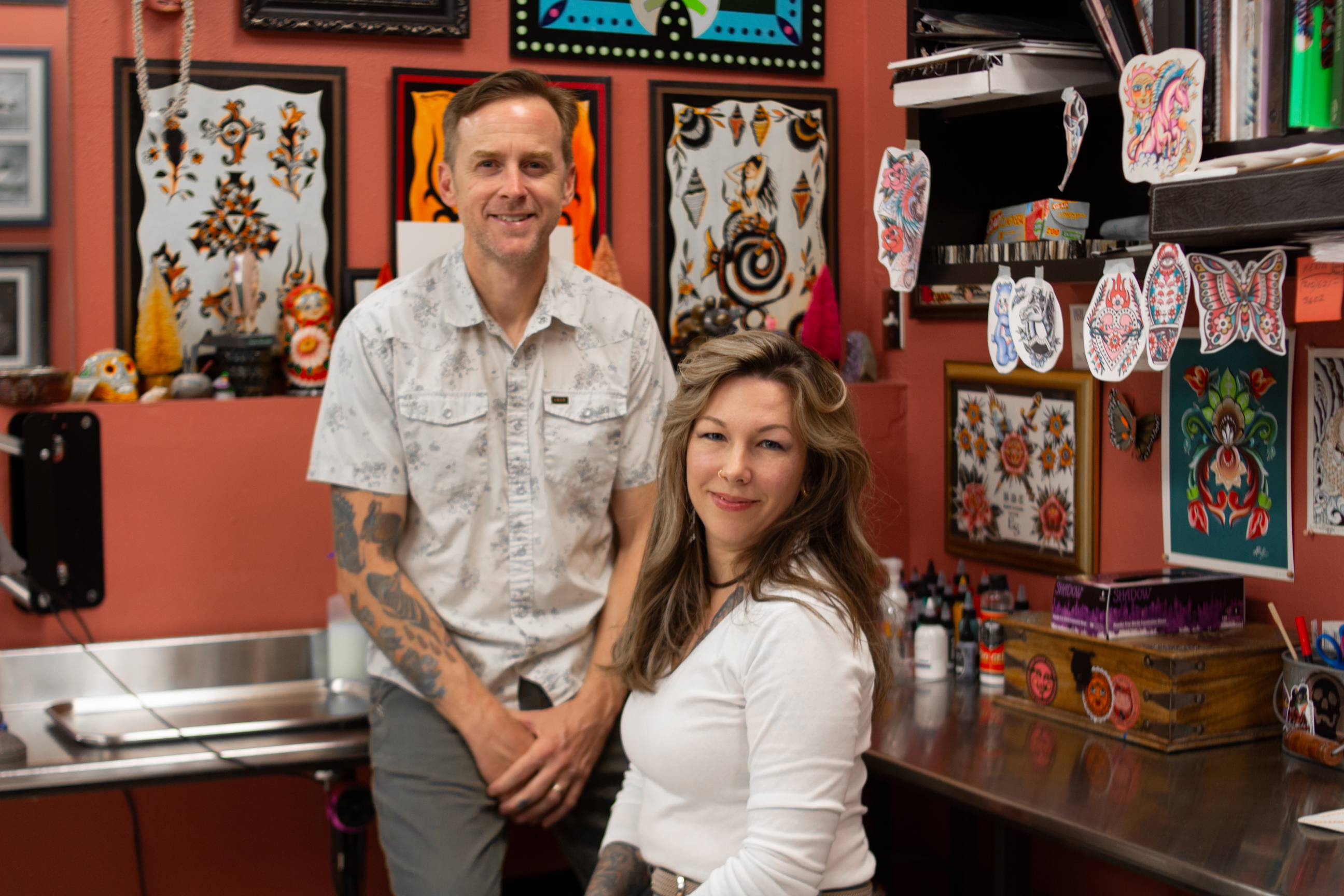 pat and morgan egan sit in their tattoo studio