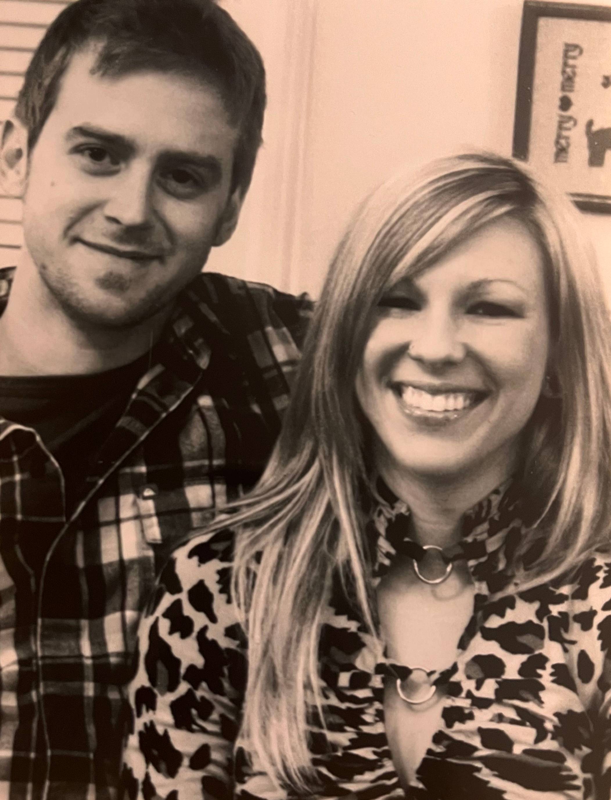 sepia colored photo of couple posing for photo and smiling