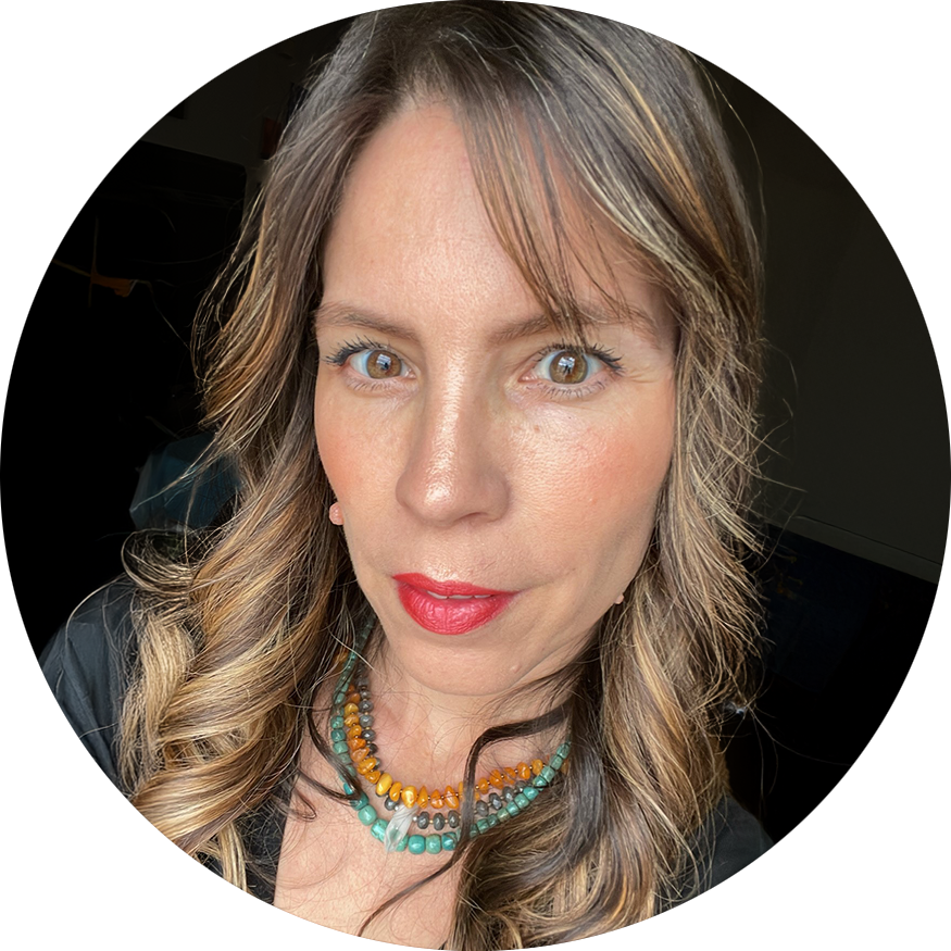 Headshot of a latina woman with light brown hair and red lipstick.