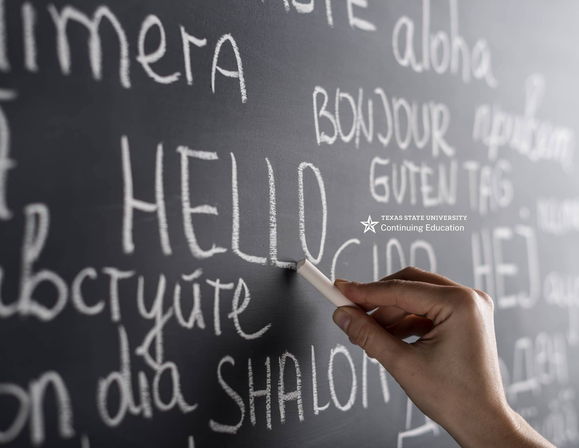 a person writing on a chalkboard with white chalk
