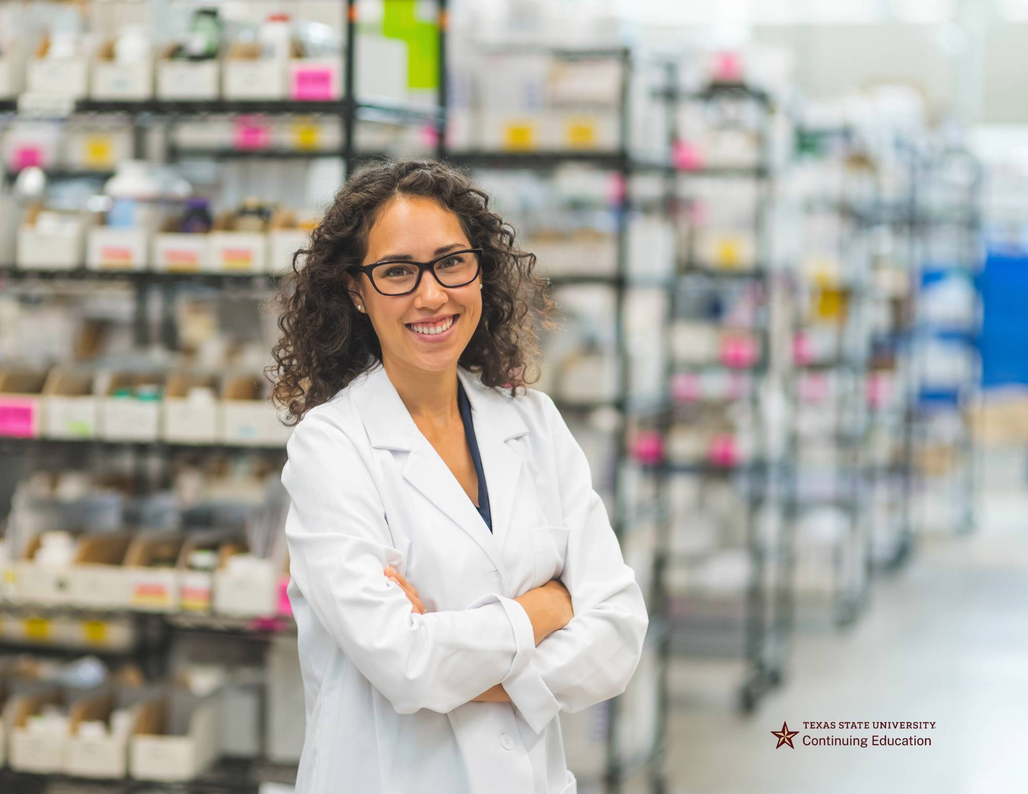 a pharmacist standing among rows of medicine