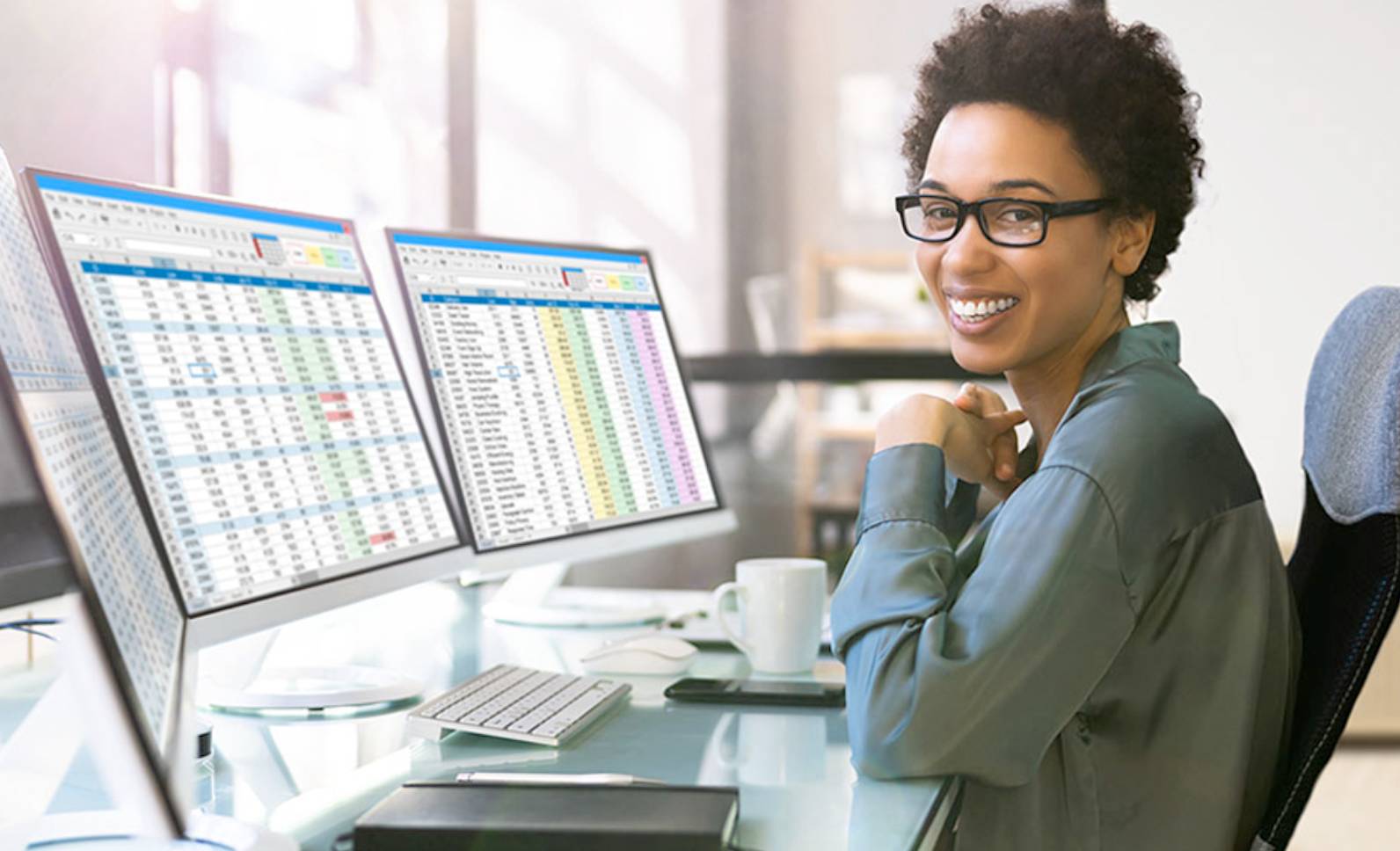 woman in front of computer looking at camera smiling