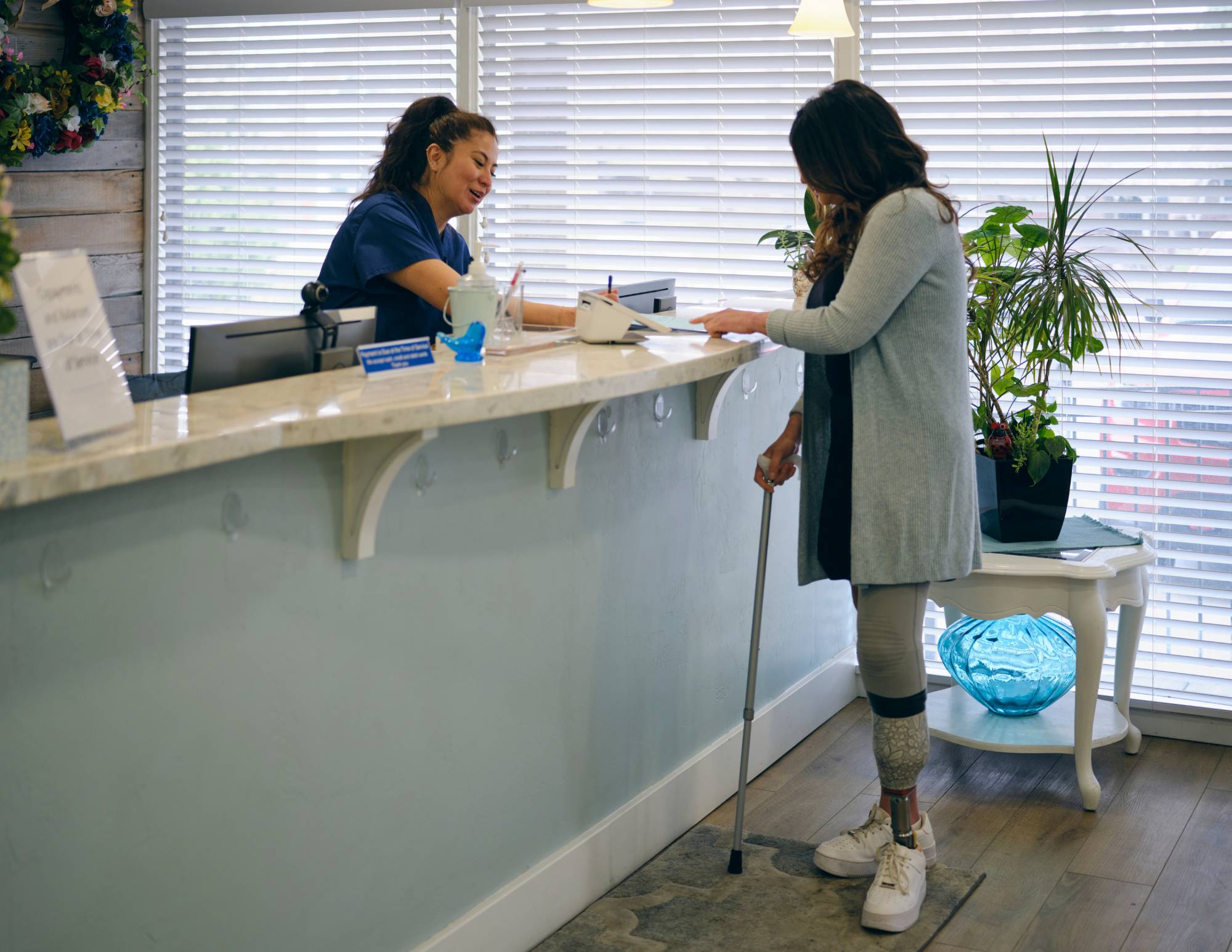 woman at front desk assisting customer with paper work