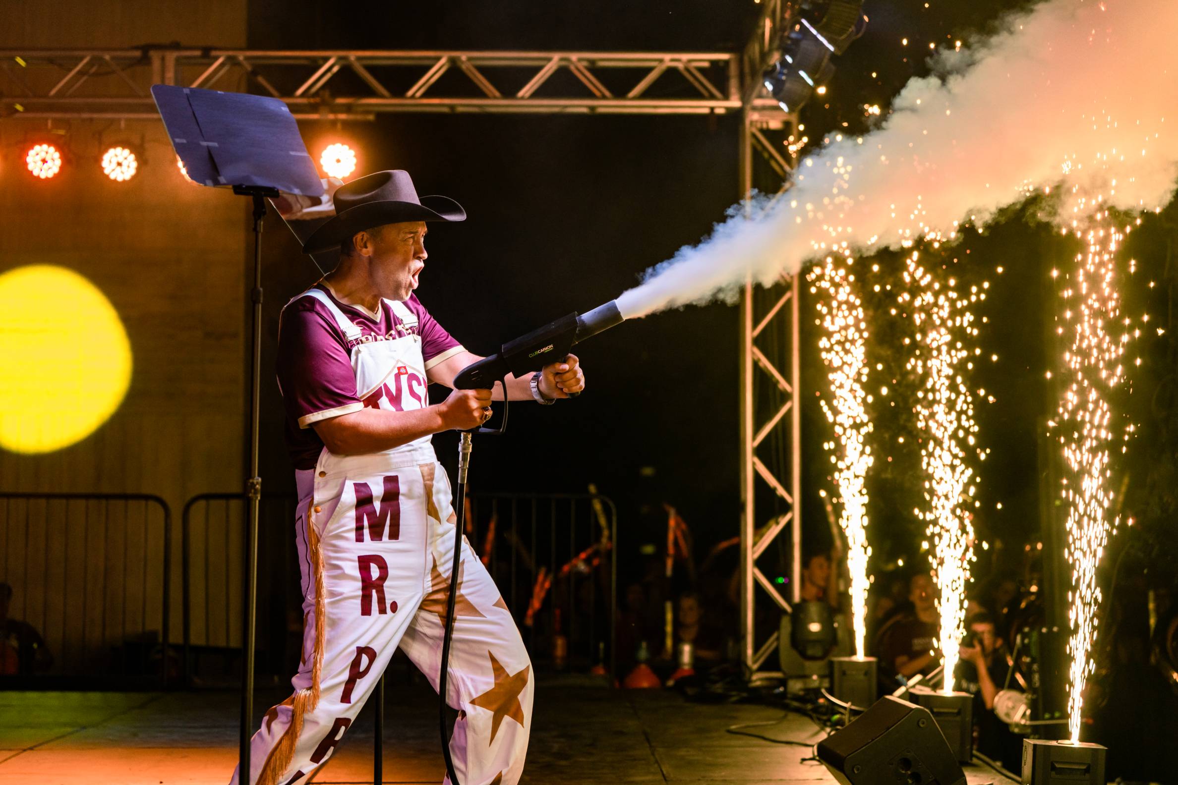 president damphousse holding co2 gun on stage