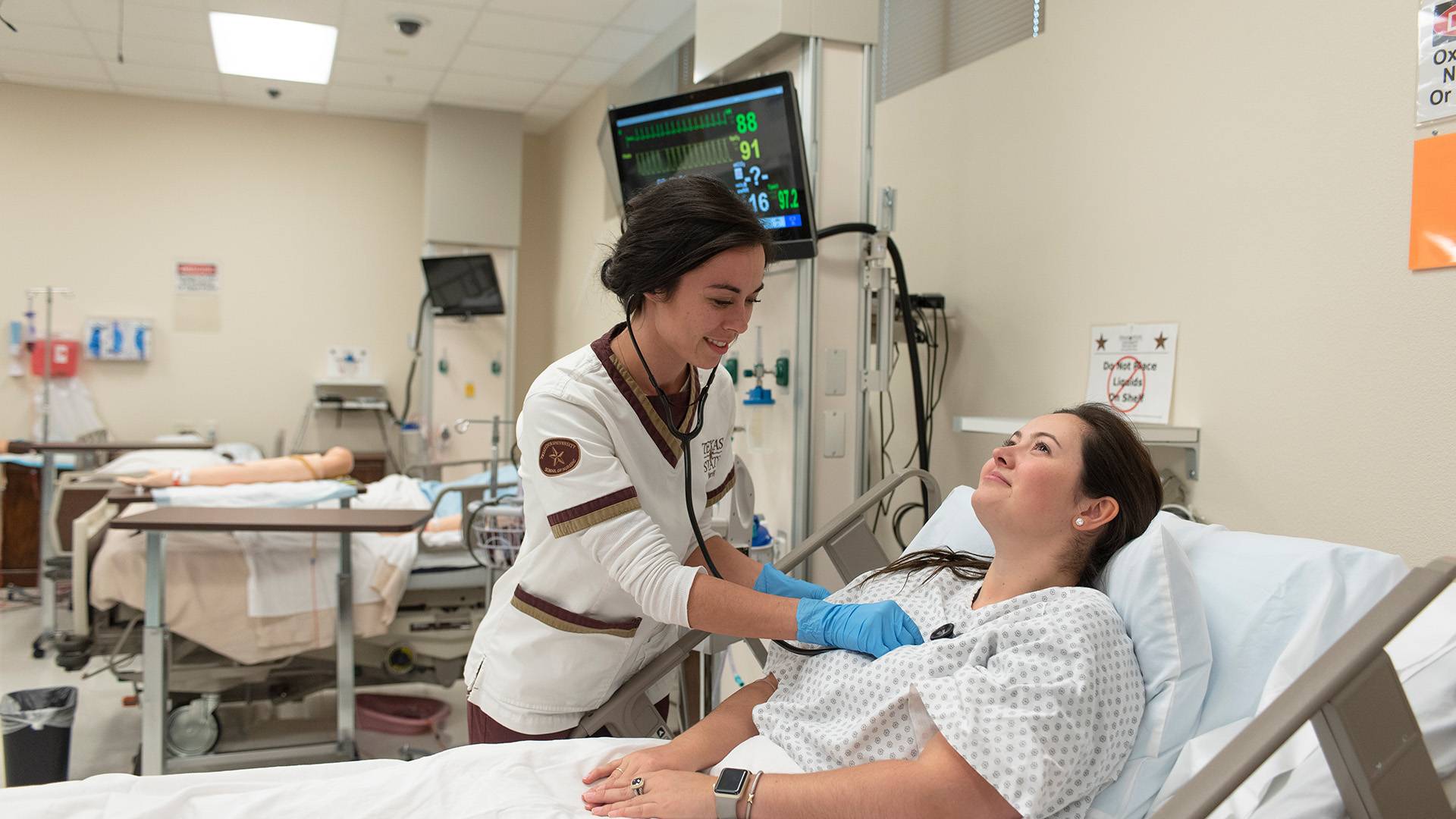 a nurse tending to a patient in a hospital bed