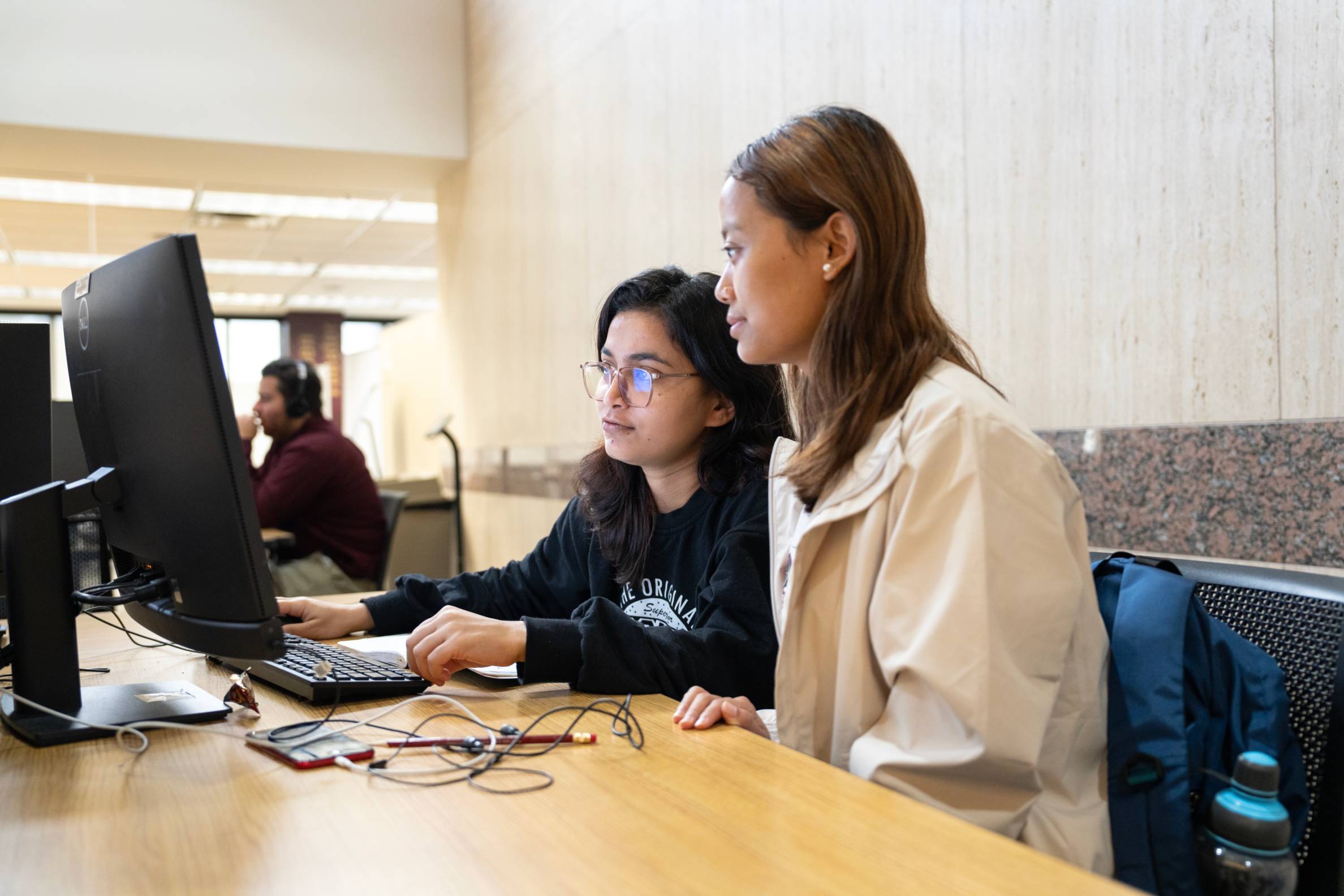 two women looking at computer monitor