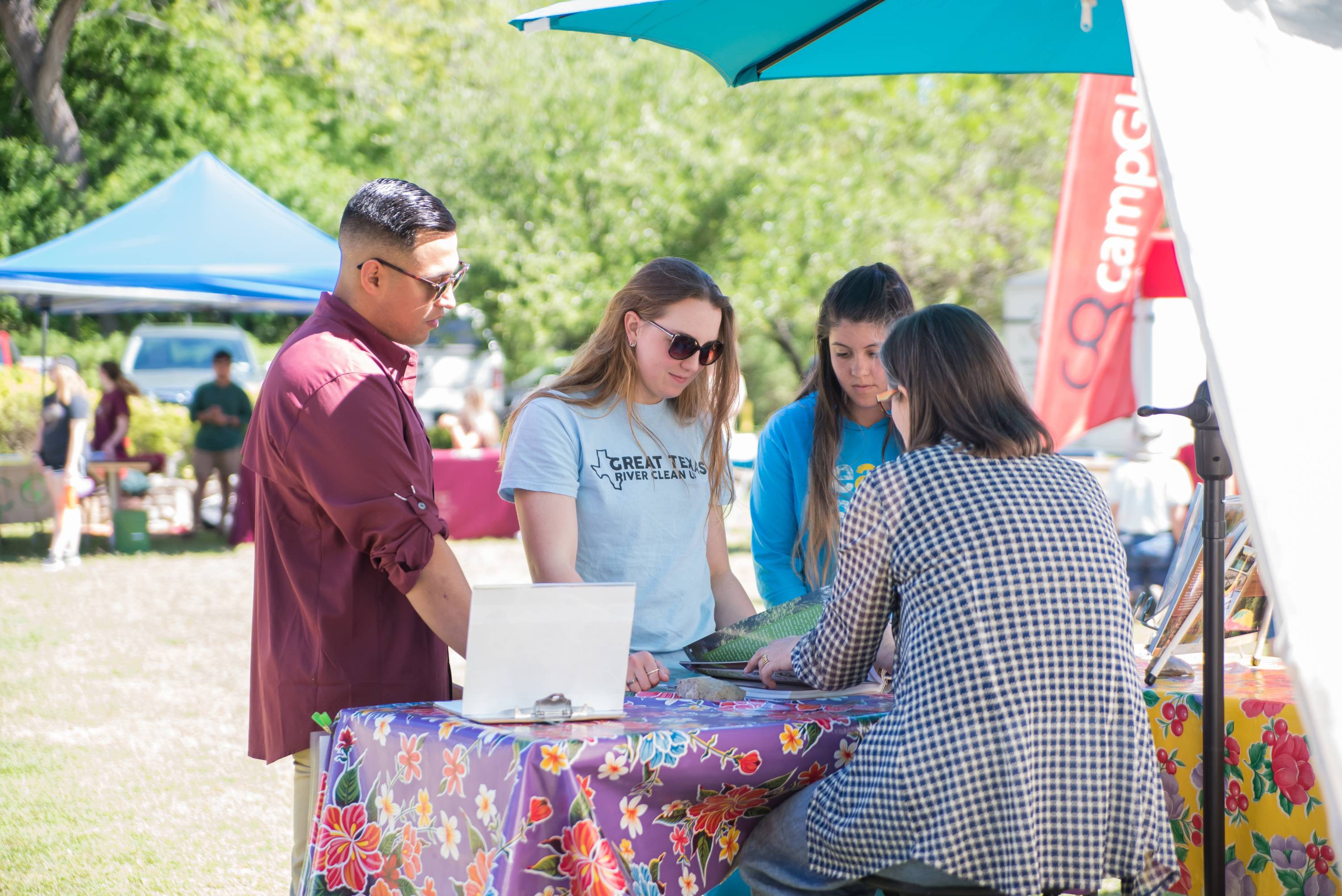 people looking down at an outdoor booth