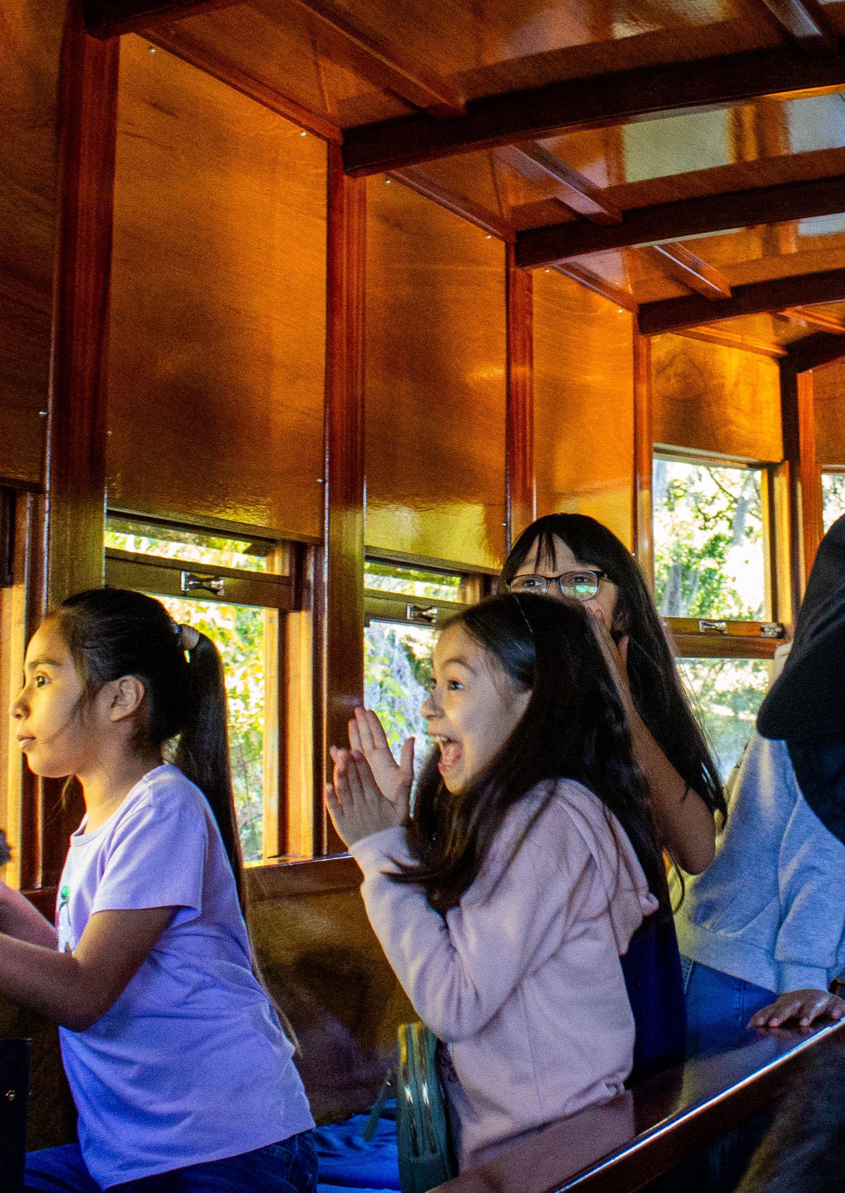 A little girl gets excited looking out of a window on one of the glass bottom boats.