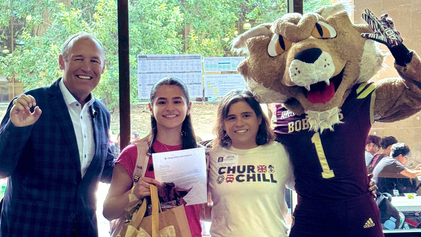 President Kelly Damphousse (left) poses for a picture with Marissa, her mother, and Boko.