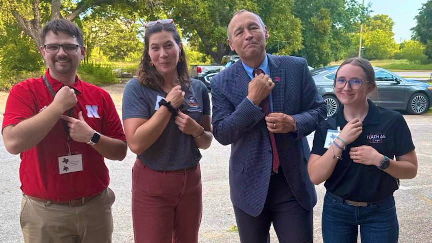President Damphousse (first right) poses for a photo agriculture staff and students.