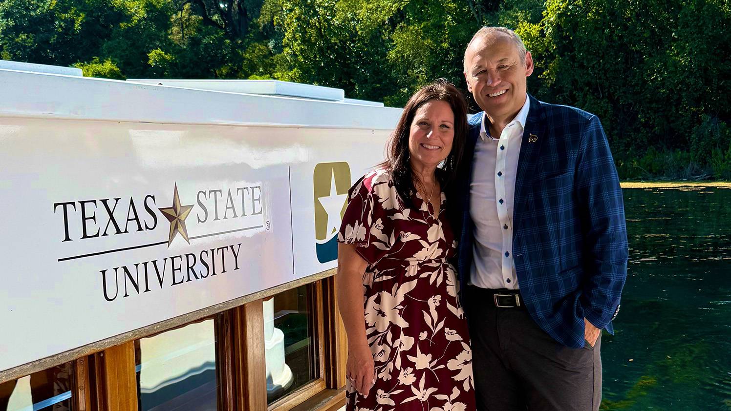 First Lady Beth Damphousse (left) poses for a photo with President Kelly Damphousse by a glass bottom boat.