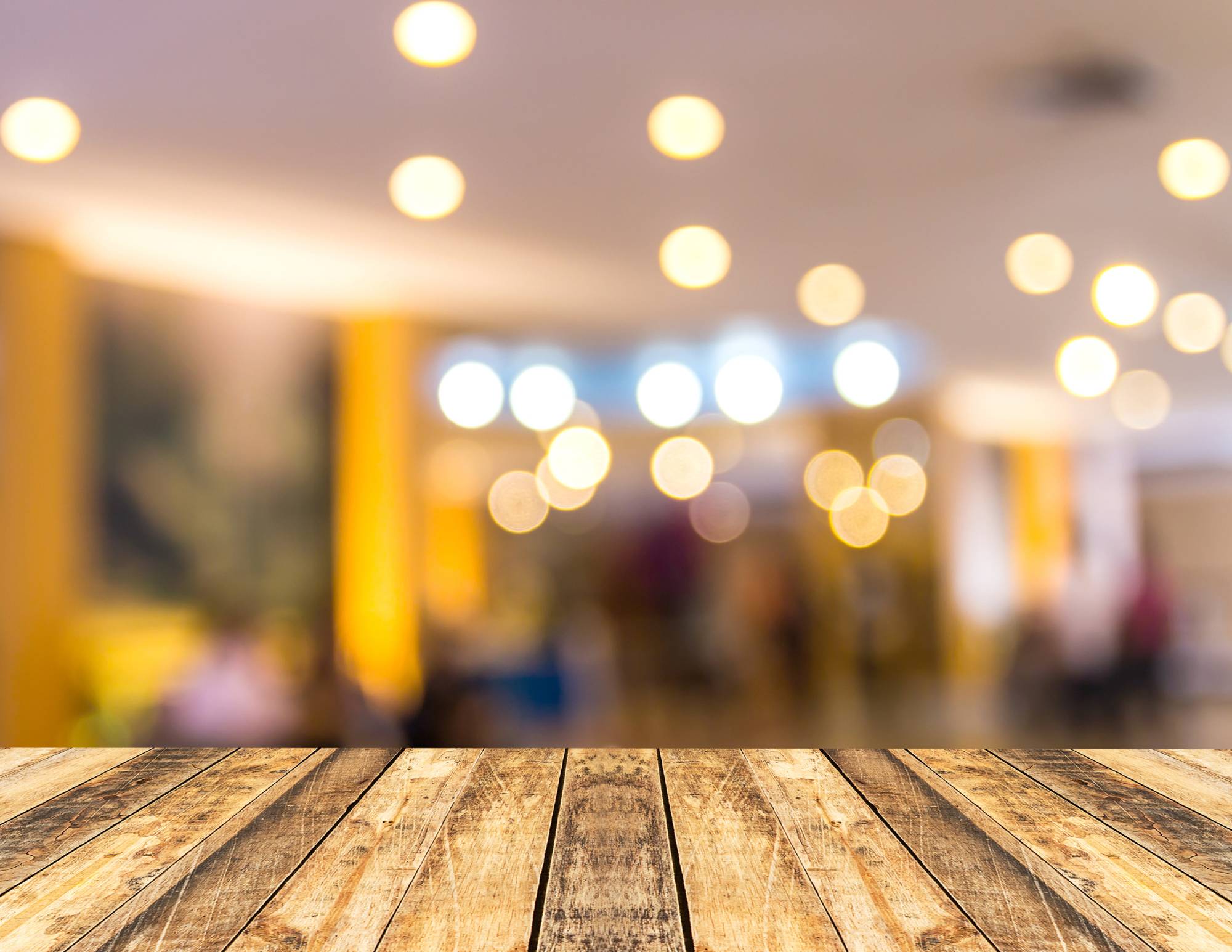wood bar with blurred lights in the distance