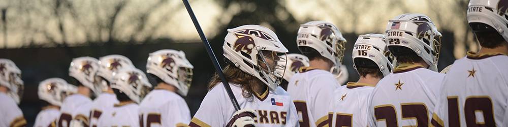 Group of students with helmets on during a lacrosse game 