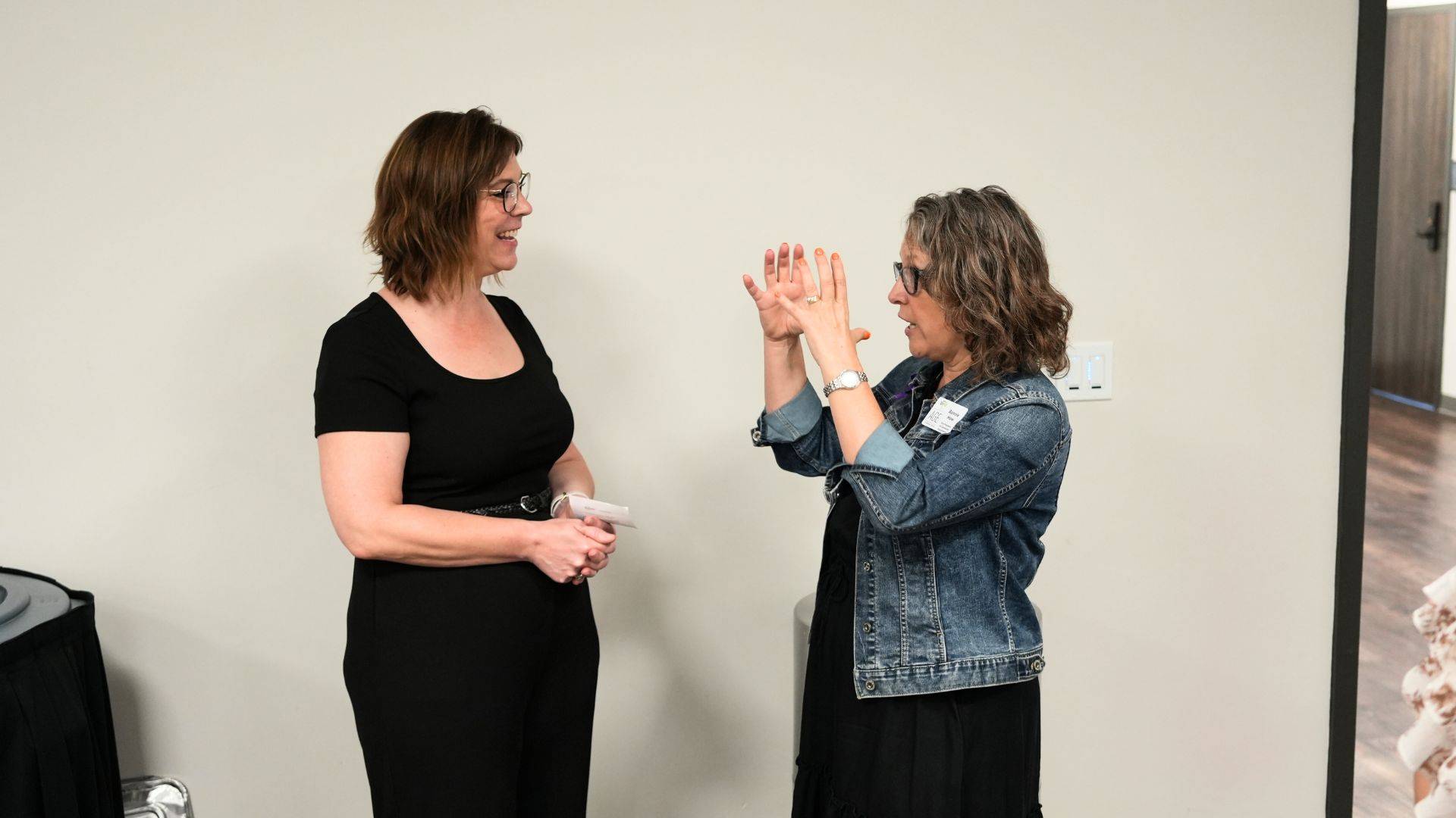 Jessica Schneider speaks to a community member at the October Health and Resilience Research Network Meeting in the LBJ Student Center