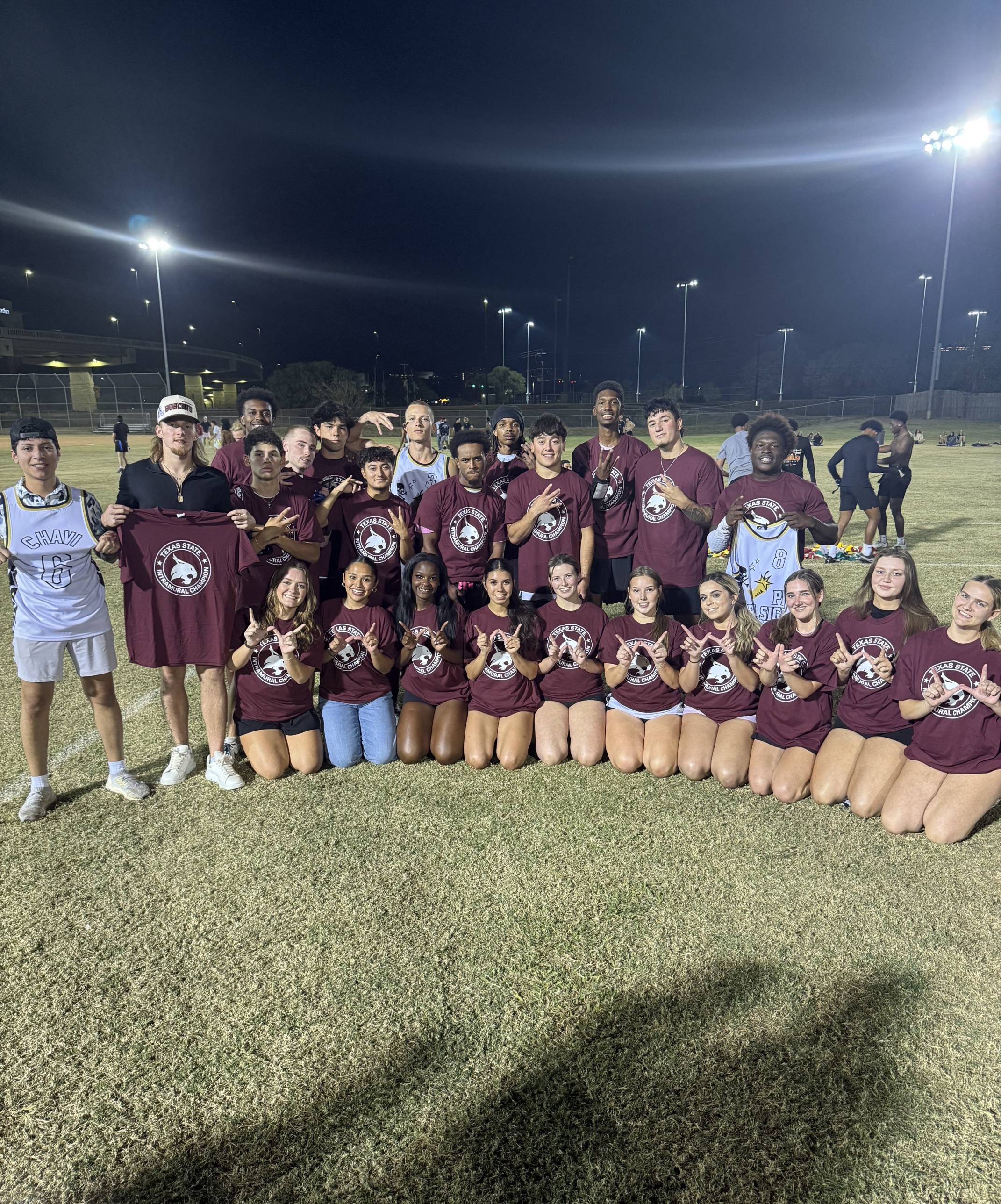 Fall 2025 Flag Football Greek CoRec Champions posing for photo with shirts