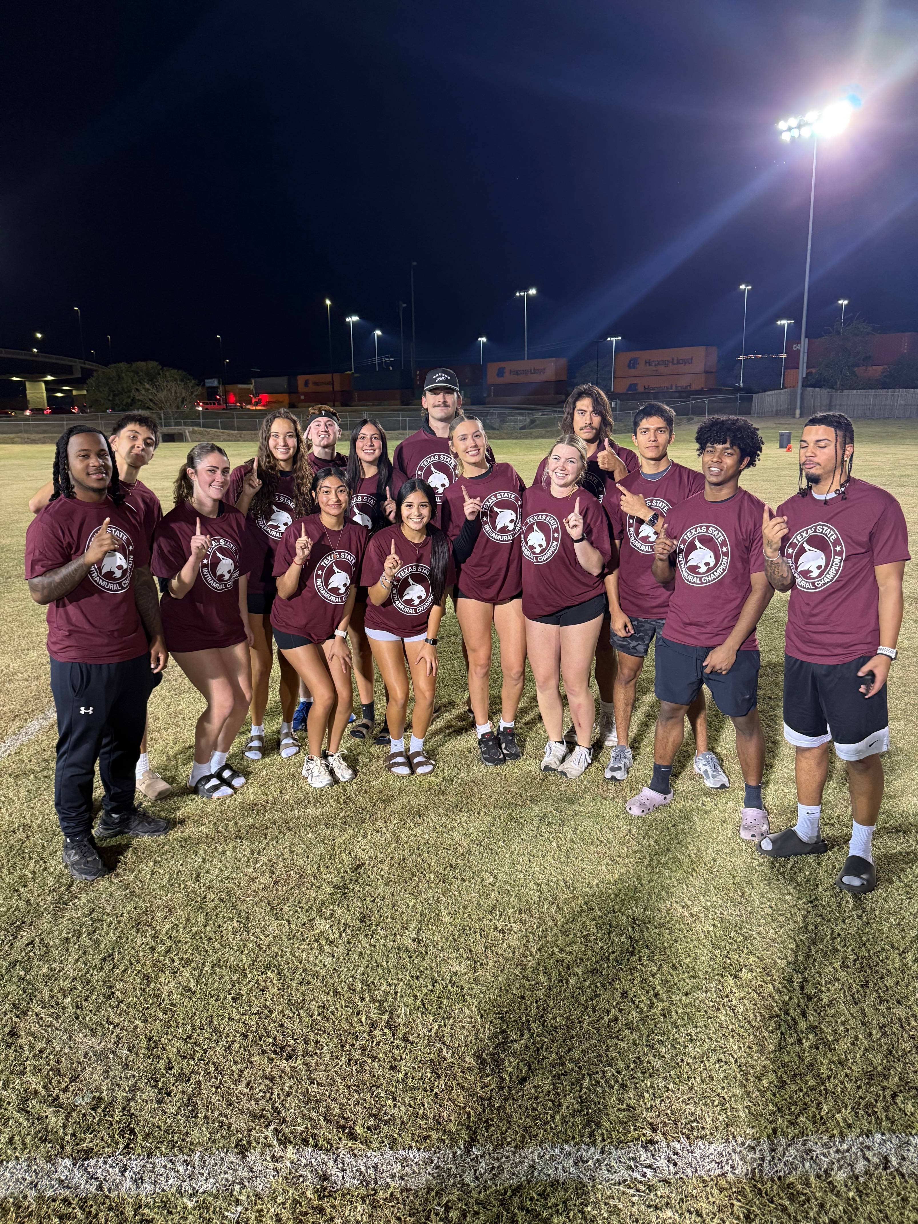 Fall 2025 Flag Football CoRec Champions posing for a photo with shirts