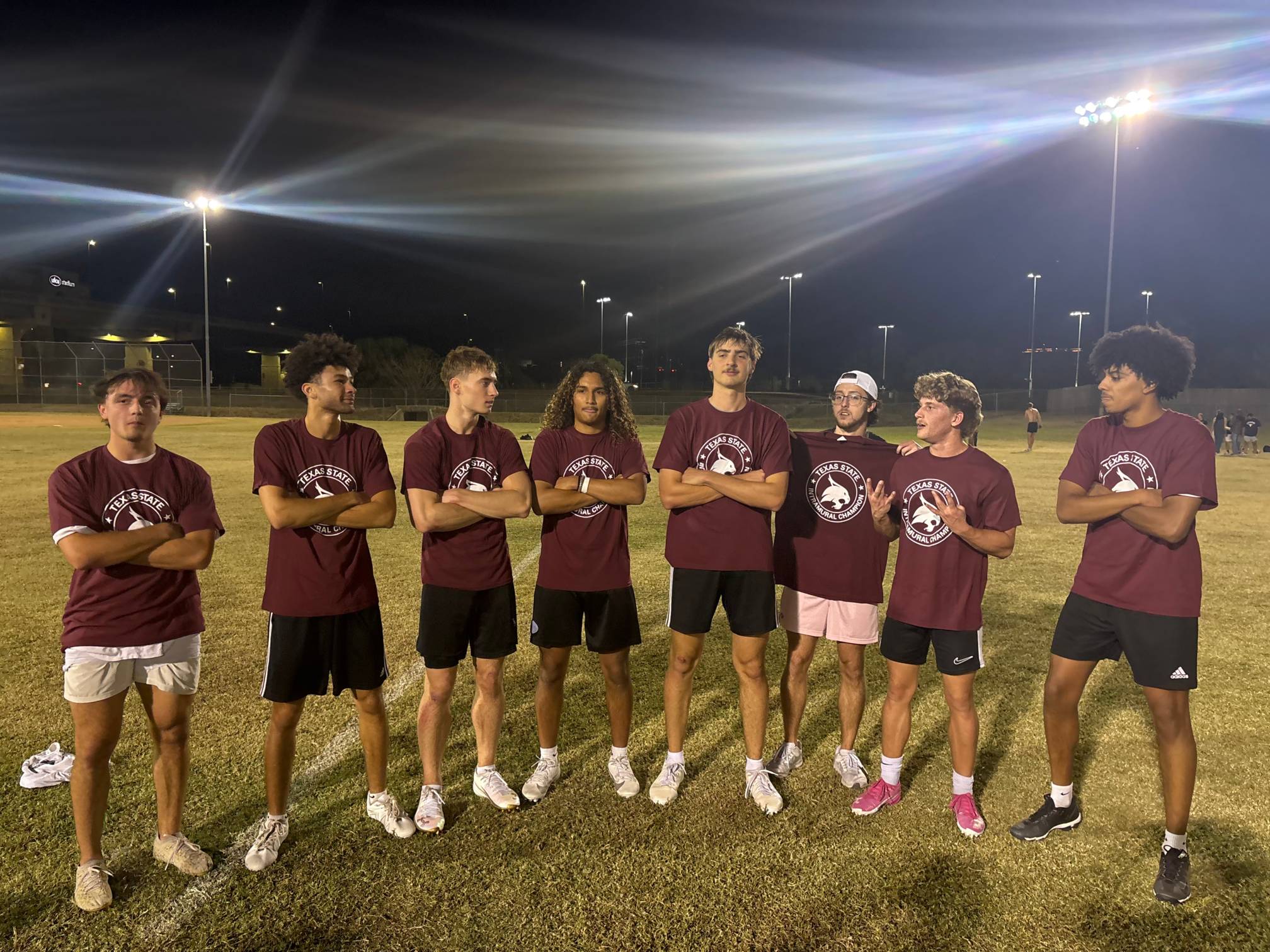 Fall 2025 Flag Football Mens B Champions pose for a picture with champ shirts