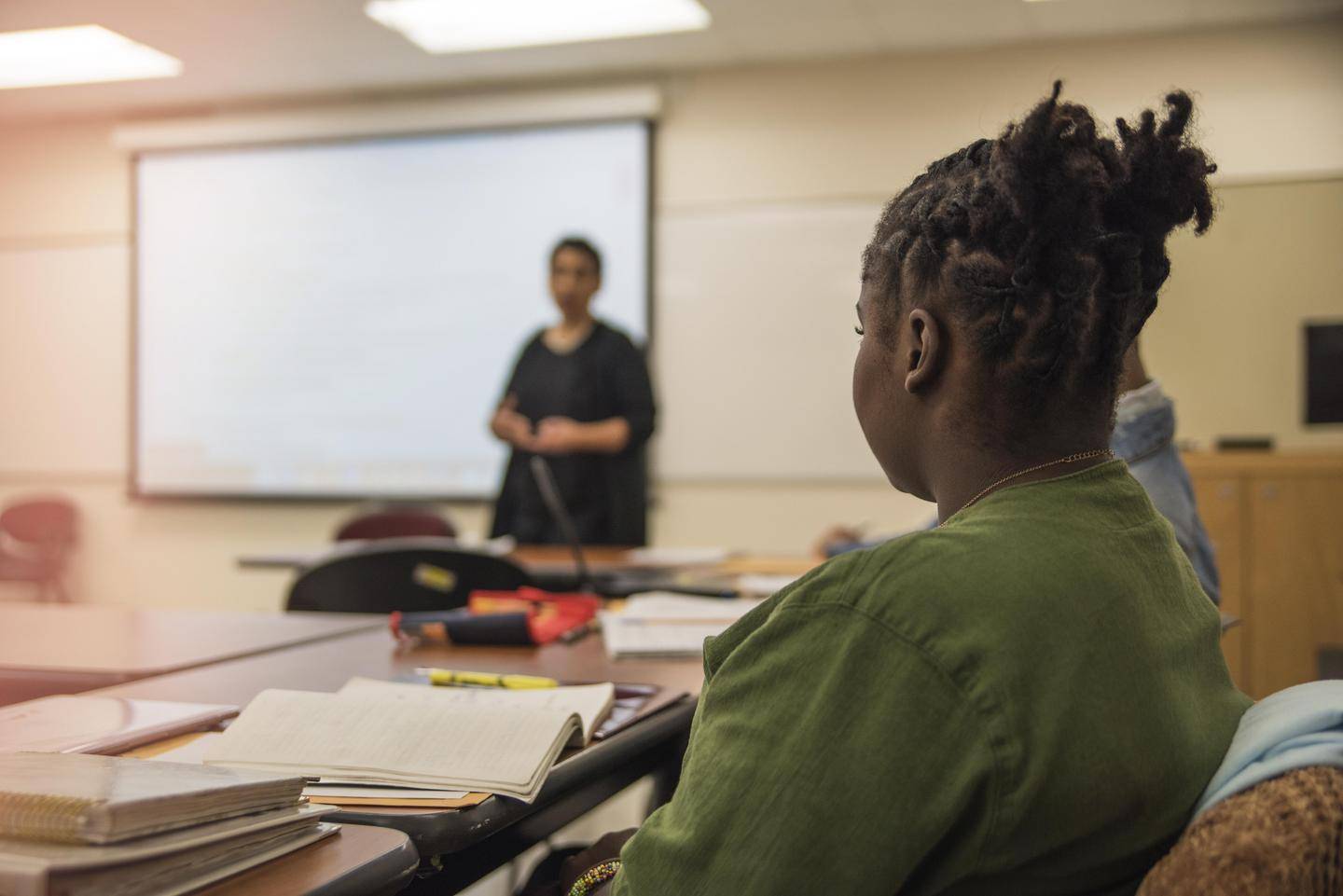 A young woman sits in class during a lecture.