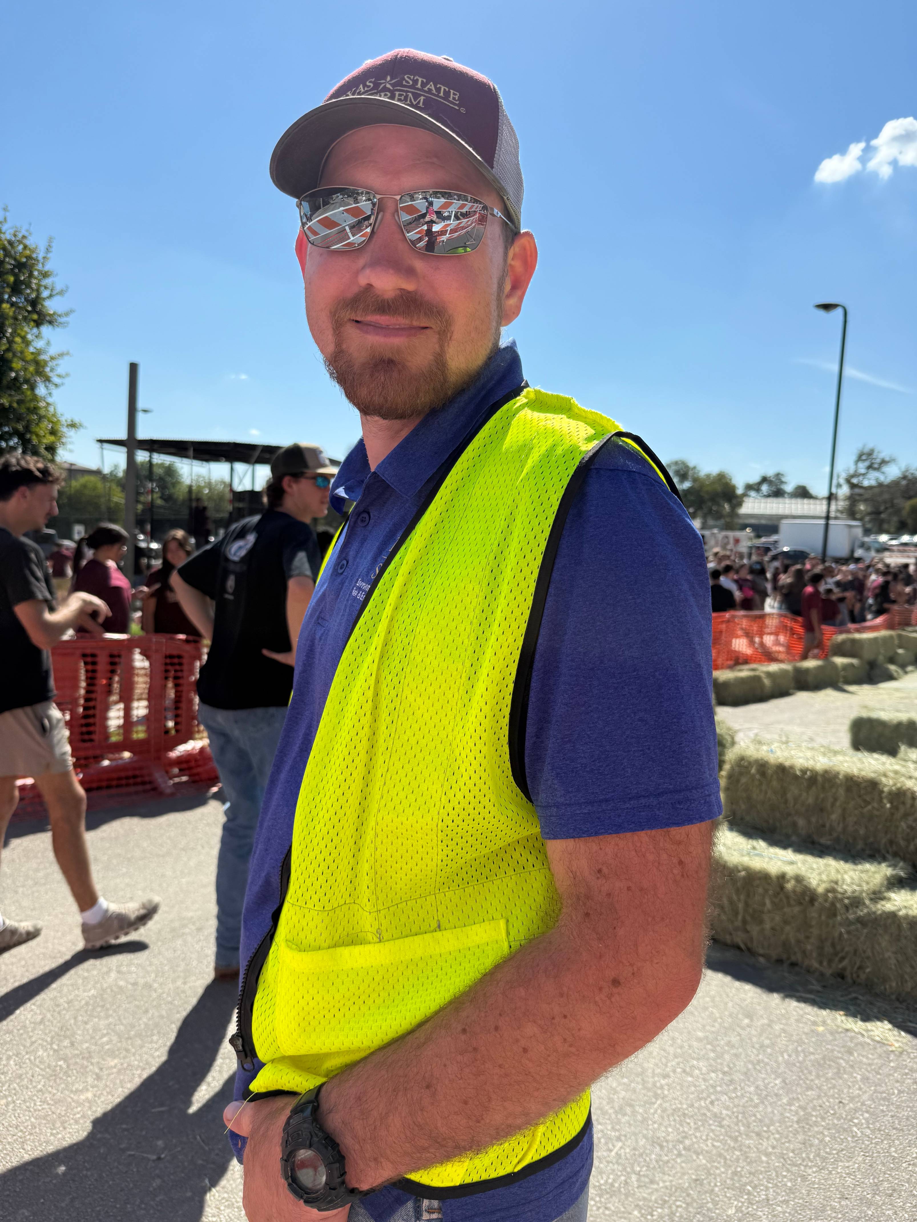 EHS Specialist, Grant Davis, posing for a picture with a red Texas State fleet truck in the background.