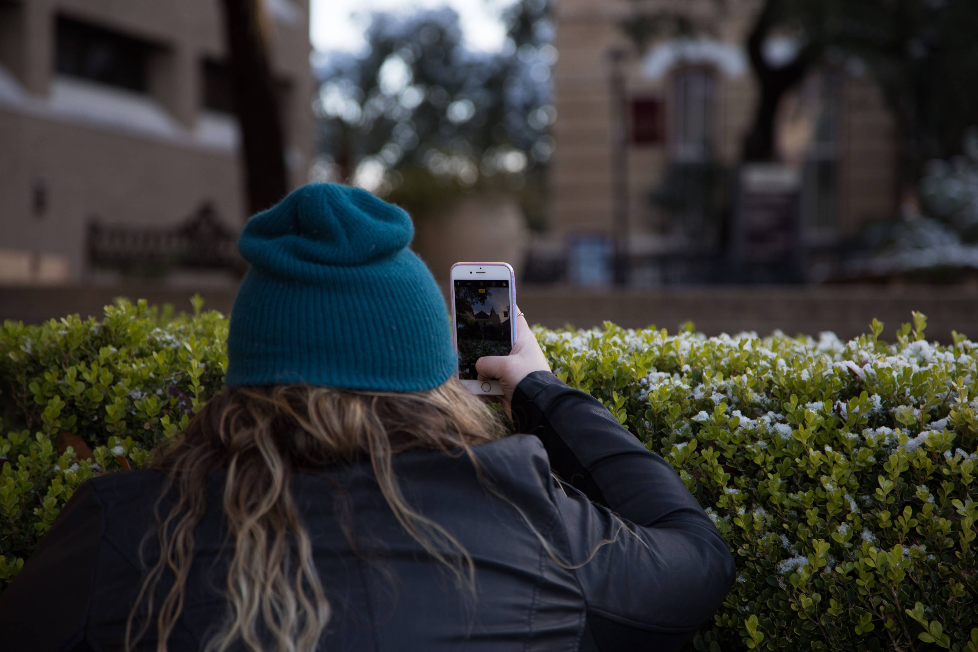 Woman taking photos on a snow day.