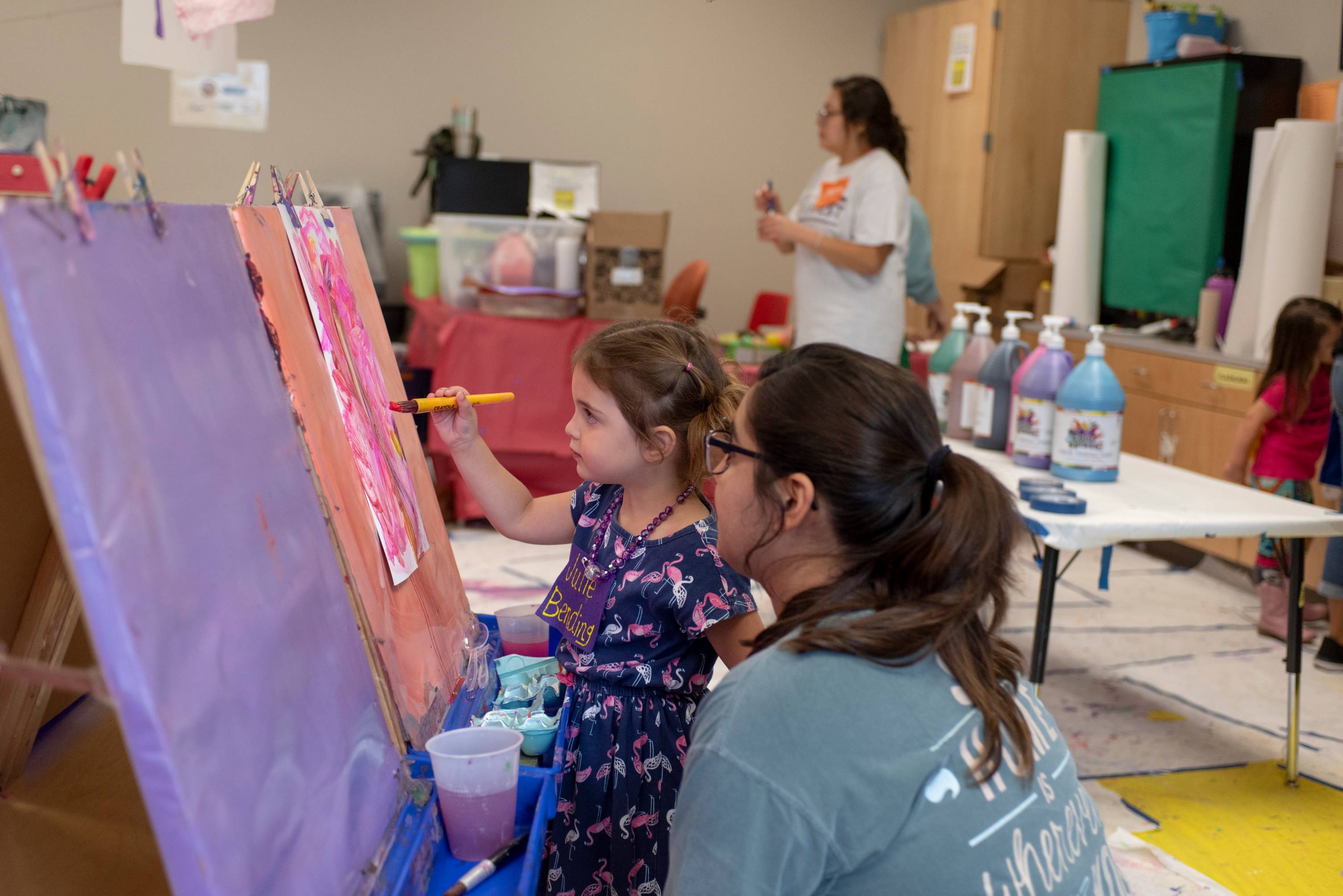 a young student painting in a classroom