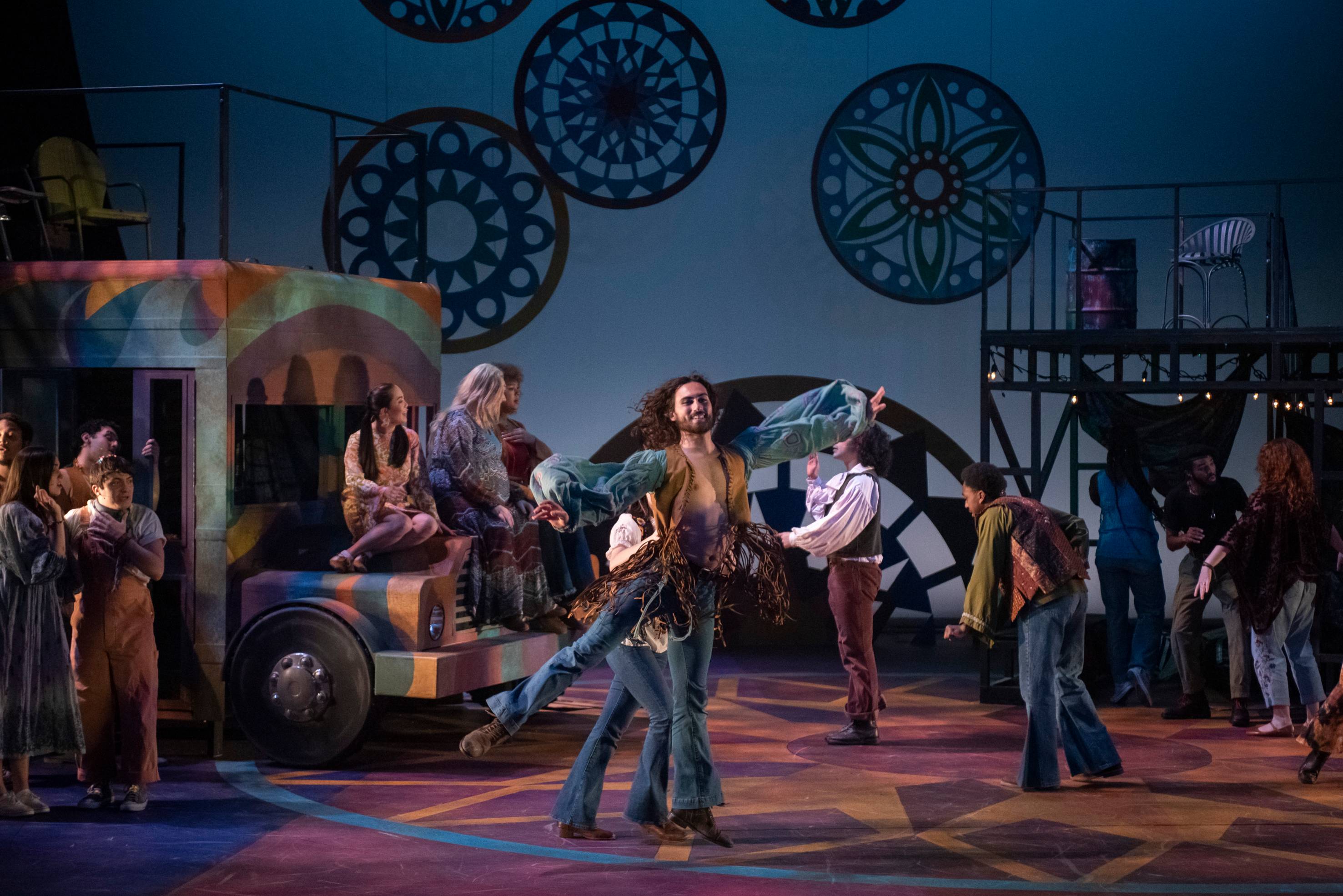 students acting and dancing on a colorful stage